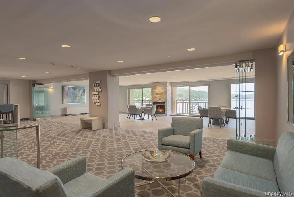 Communal seating area in the Paradise Harbor lobby with fireplace and Hudson River views. Communal seating area in the Paradise Harbor lobby with fireplace and Hudson River views.