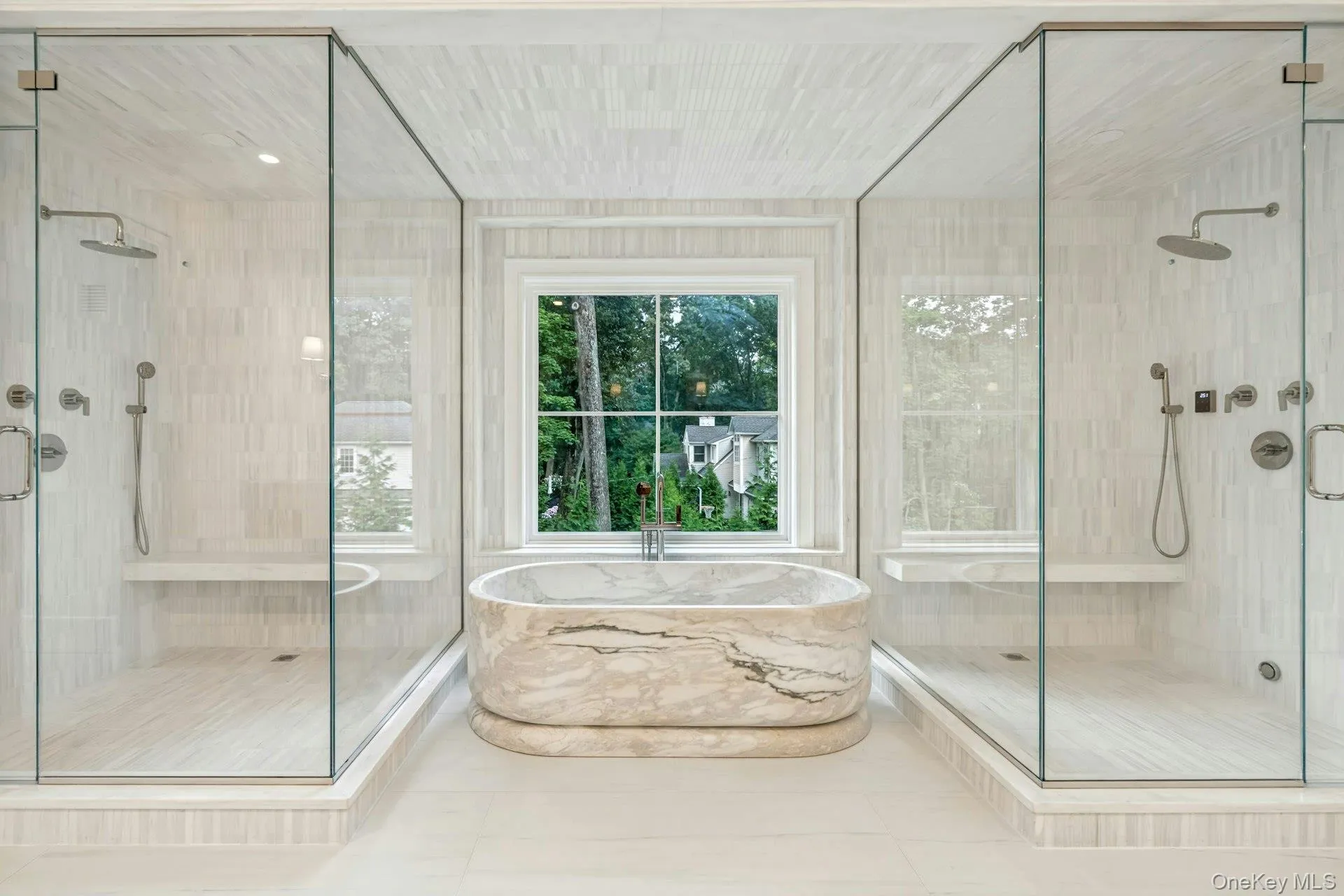 Primary Bathroom with 2 showers and a marble tub Primary Bathroom with 2 showers and a marble tub