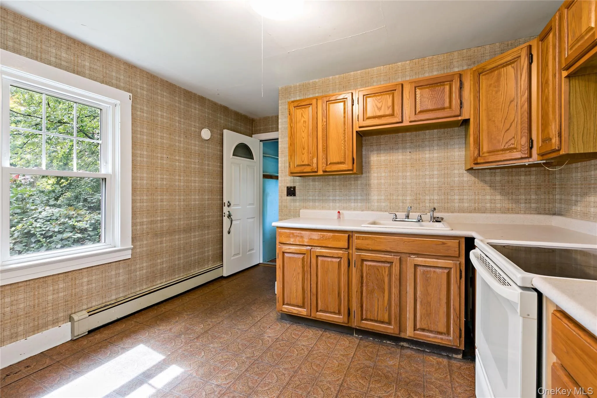 Kitchen with door out to back deck. Kitchen with door out to back deck.