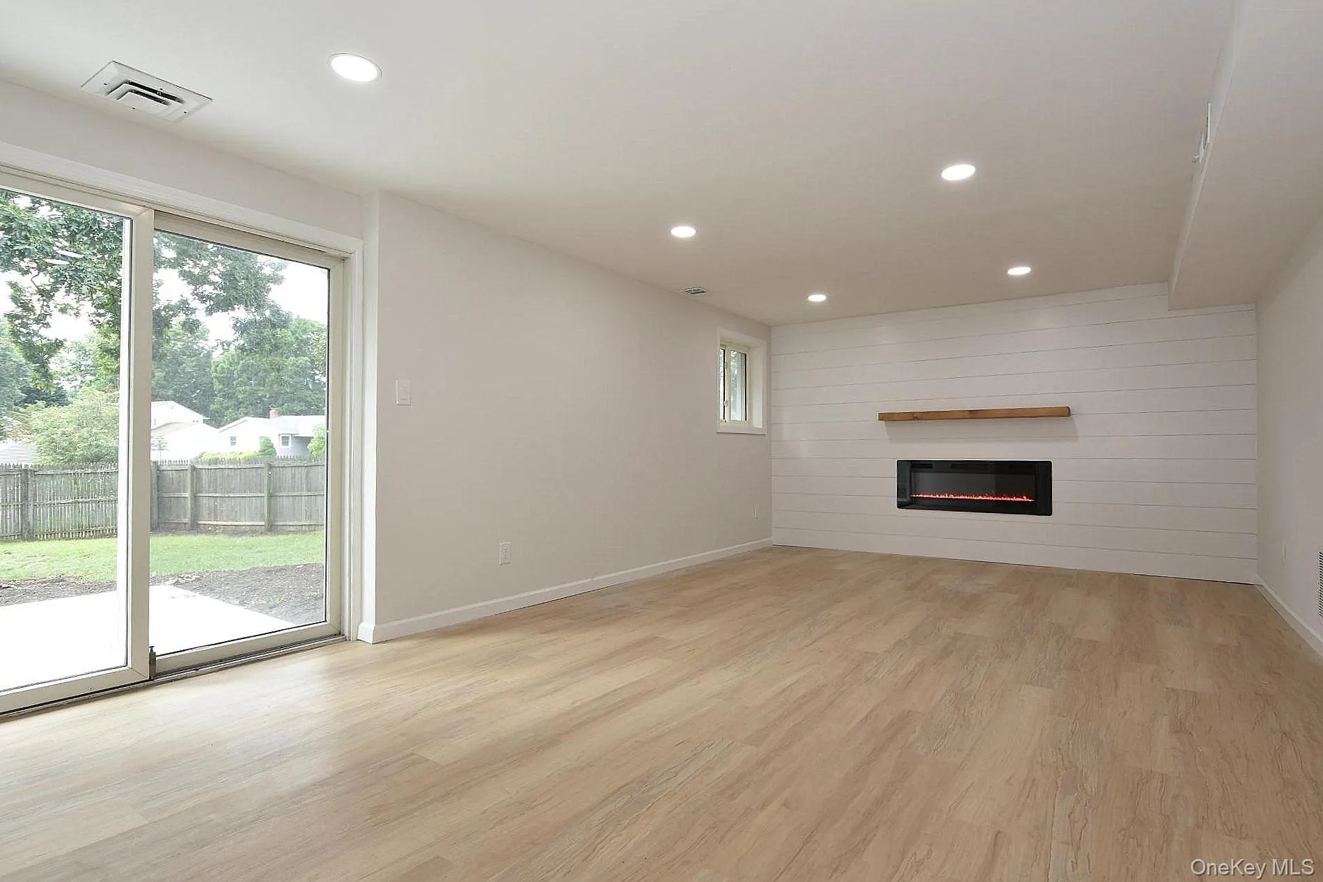 Lower Level Den with sliders to the patio and fireplace Lower Level Den with sliders to the patio and fireplace