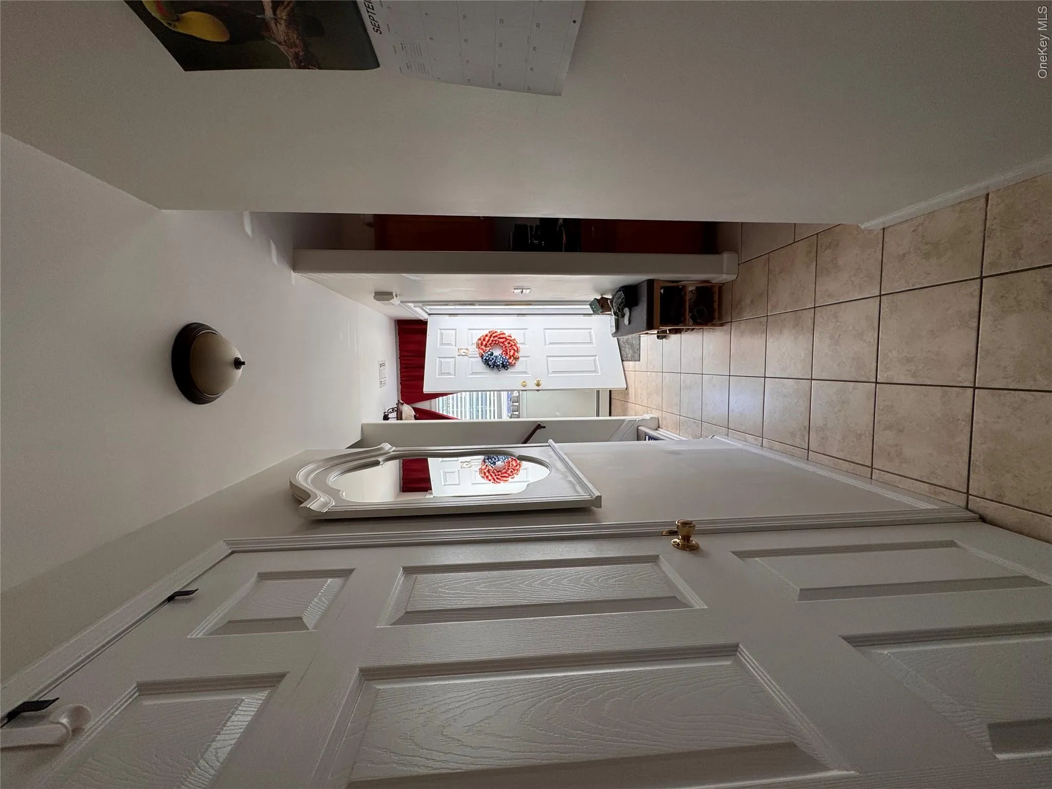 Coat closet, lavatory, door leading to full basement. Coat closet, lavatory, door leading to full basement.