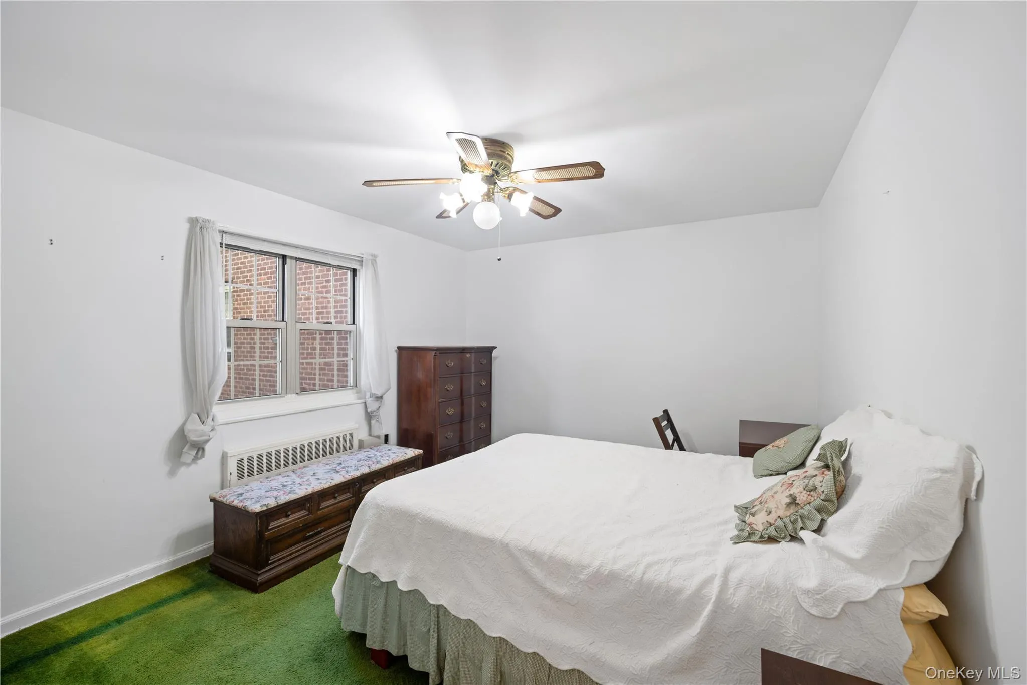 White walls with green carpeting White walls with green carpeting