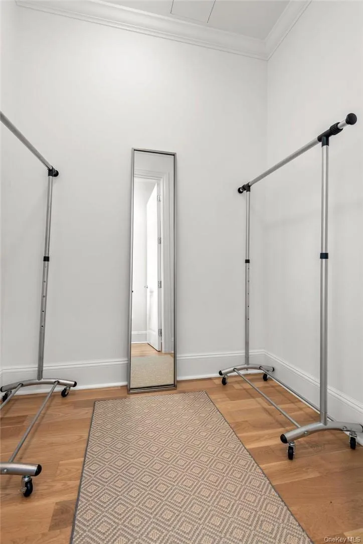 Exercise room with hardwood / wood-style floors and crown molding Exercise room with hardwood / wood-style floors and crown molding