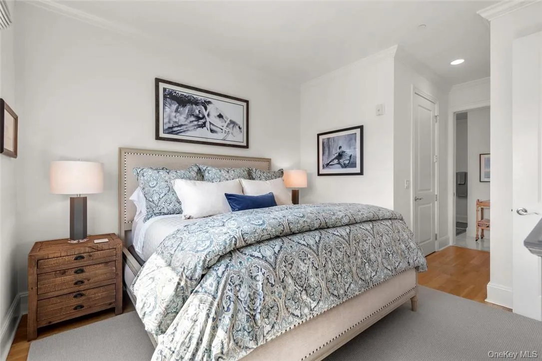 Bedroom with wood-type flooring and ornamental molding Bedroom with wood-type flooring and ornamental molding