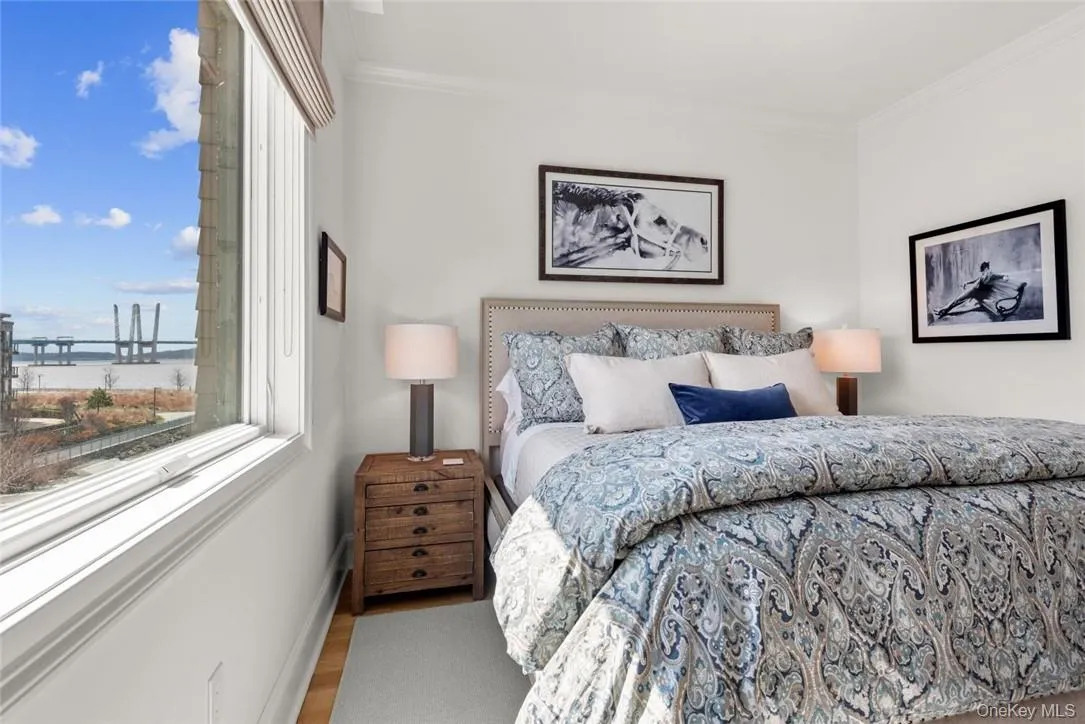 Bedroom featuring crown molding and wood-type flooring Bedroom featuring crown molding and wood-type flooring