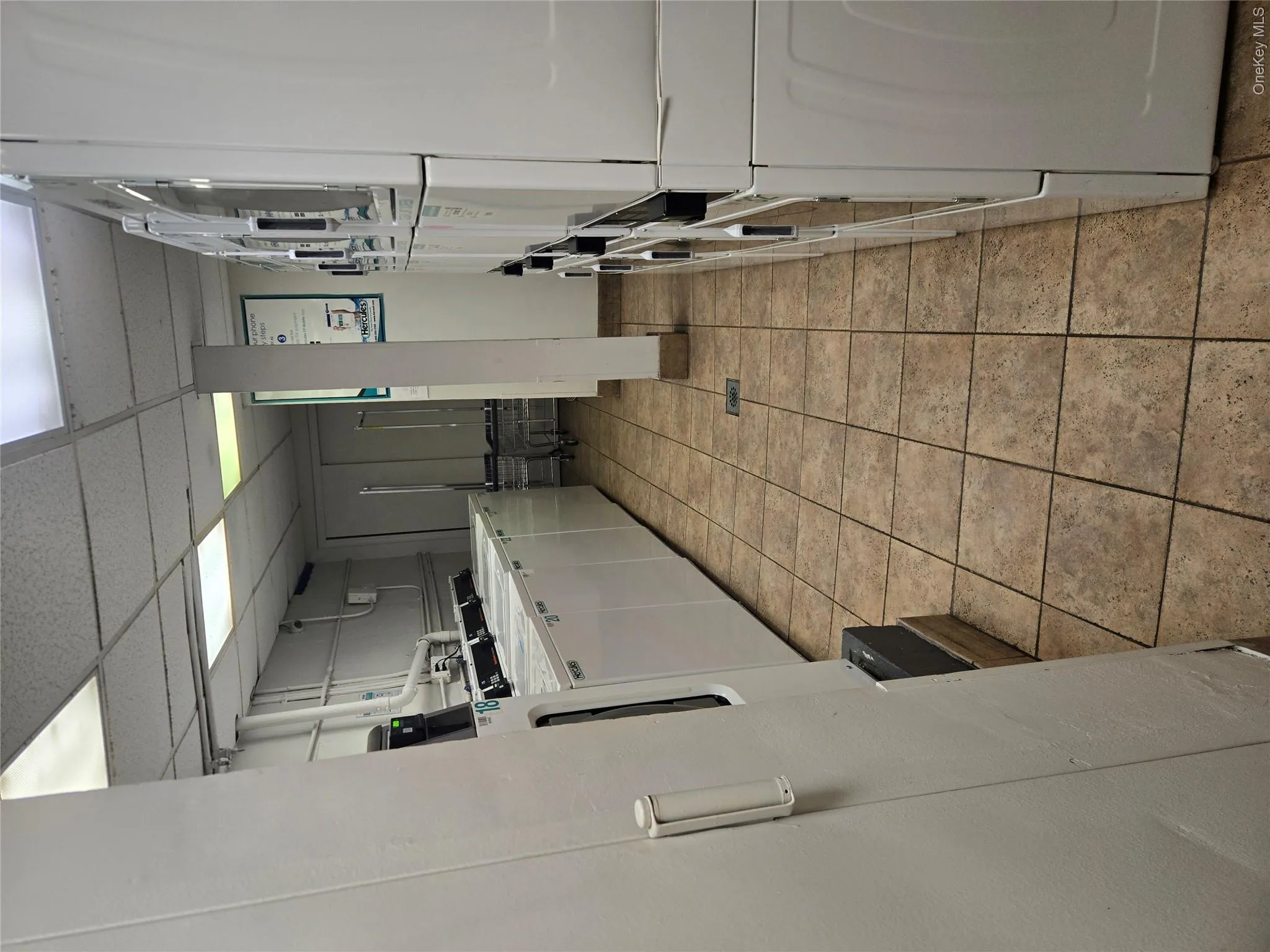 Dedicated laundry facility featuring multiple commercial-grade washers and dryers Dedicated laundry facility featuring multiple commercial-grade washers and dryers