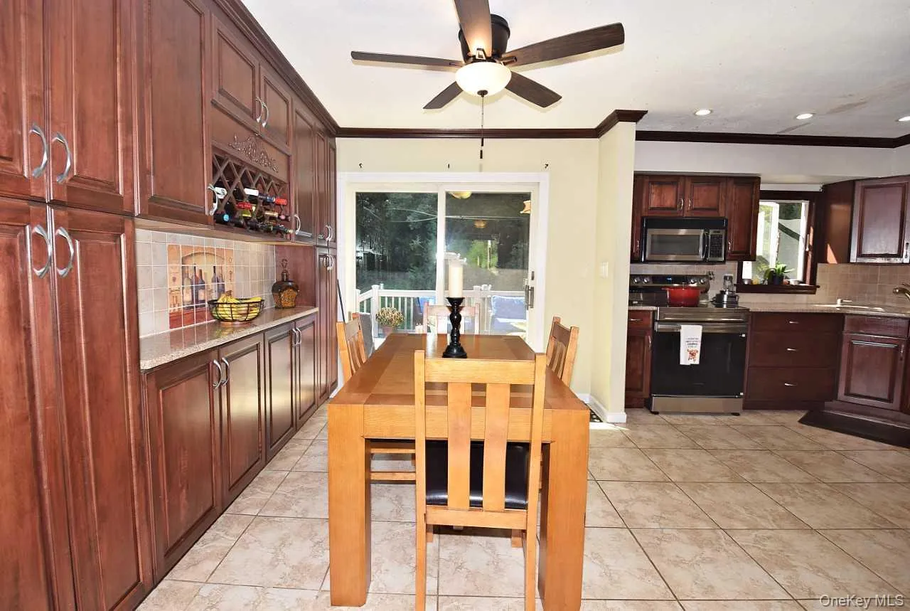 Wood-finish cabinetry, tile flooring, granite countertops, tile backsplash, and stainless steel appliances Wood-finish cabinetry, tile flooring, granite countertops, tile backsplash, and stainless steel appliances