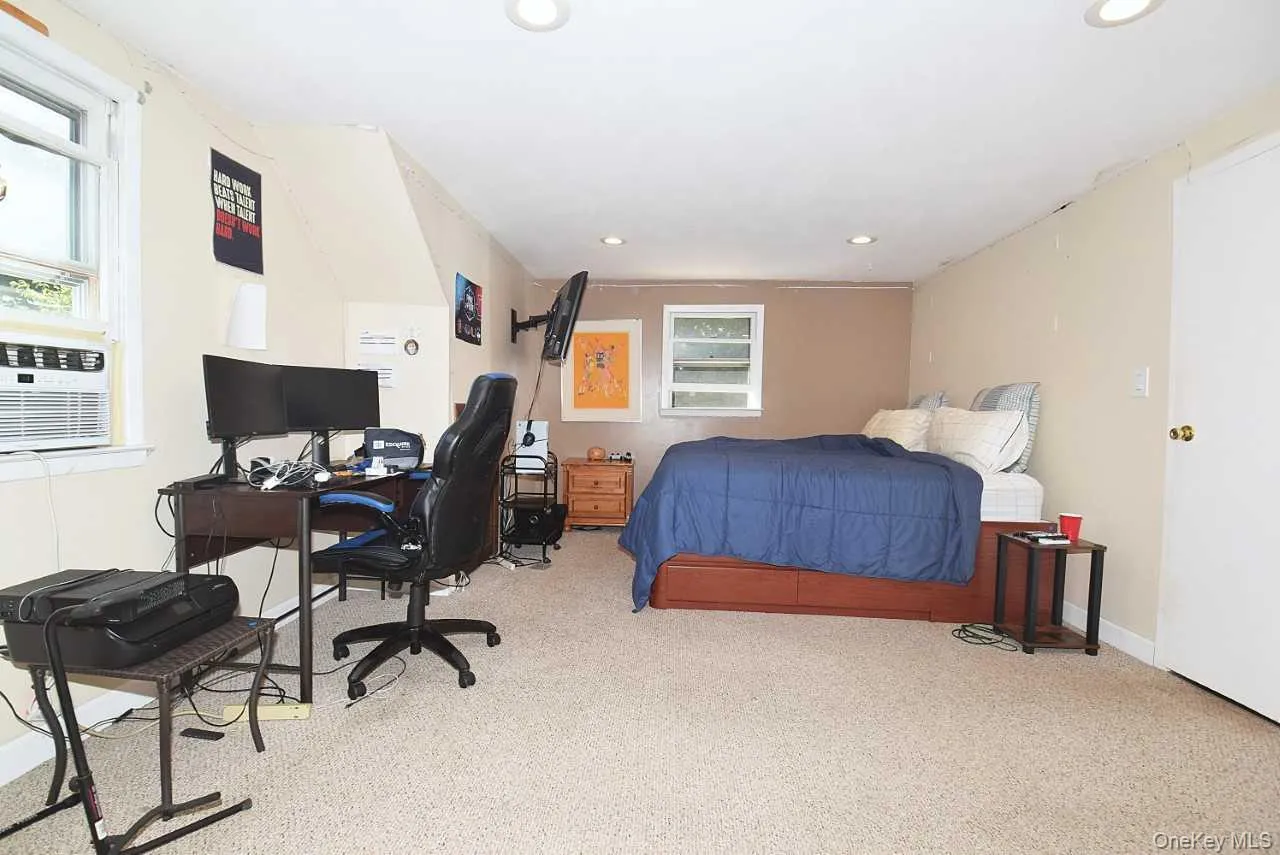 Carpeted room with recessed lighting and multiple windows Carpeted room with recessed lighting and multiple windows