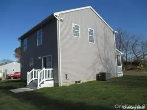 View of home's exterior with a yard and a central air condition unit View of home's exterior with a yard and a central air condition unit