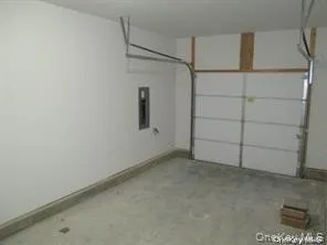 Garage with electric panel and baseboards Garage with electric panel and baseboards