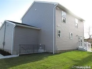 View of property exterior featuring a yard View of property exterior featuring a yard