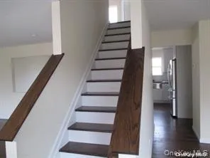 Stairway with wood finished floors and baseboards Stairway with wood finished floors and baseboards