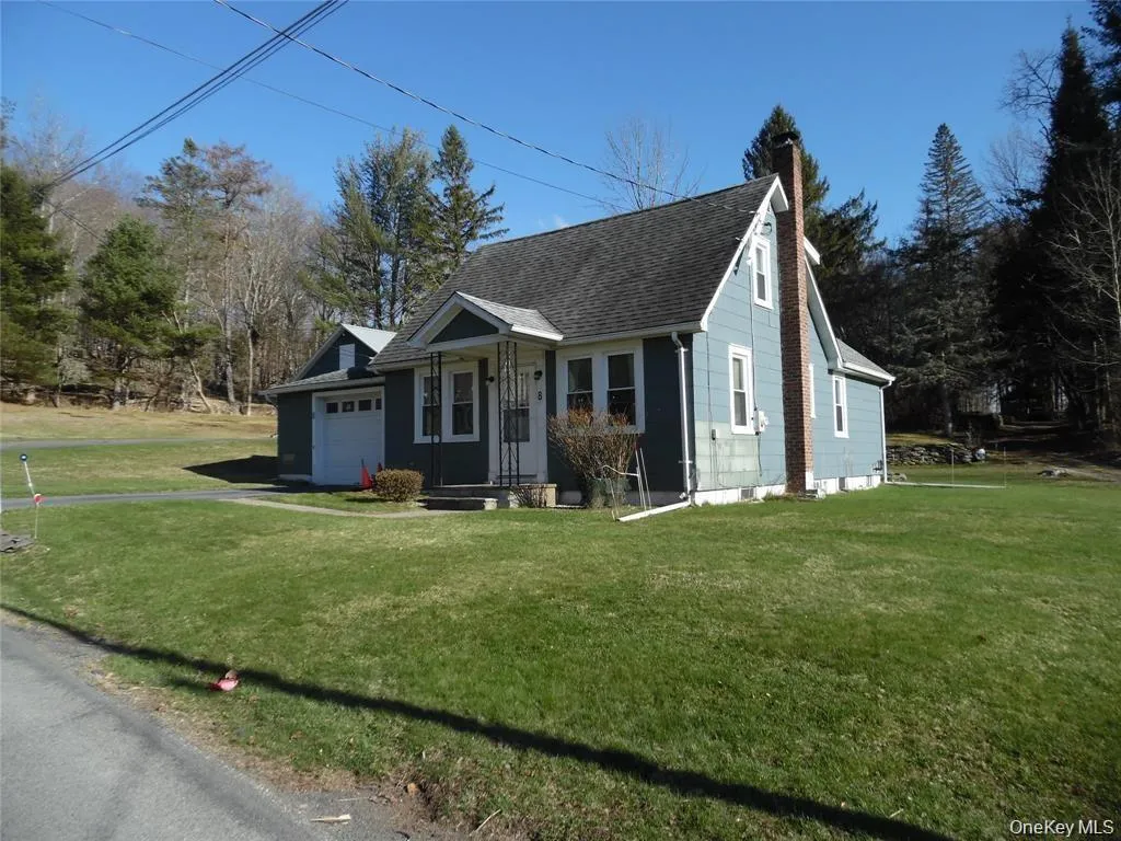 Light blue siding exterior with a dark shingle roof, brick chimney Light blue siding exterior with a dark shingle roof, brick chimney