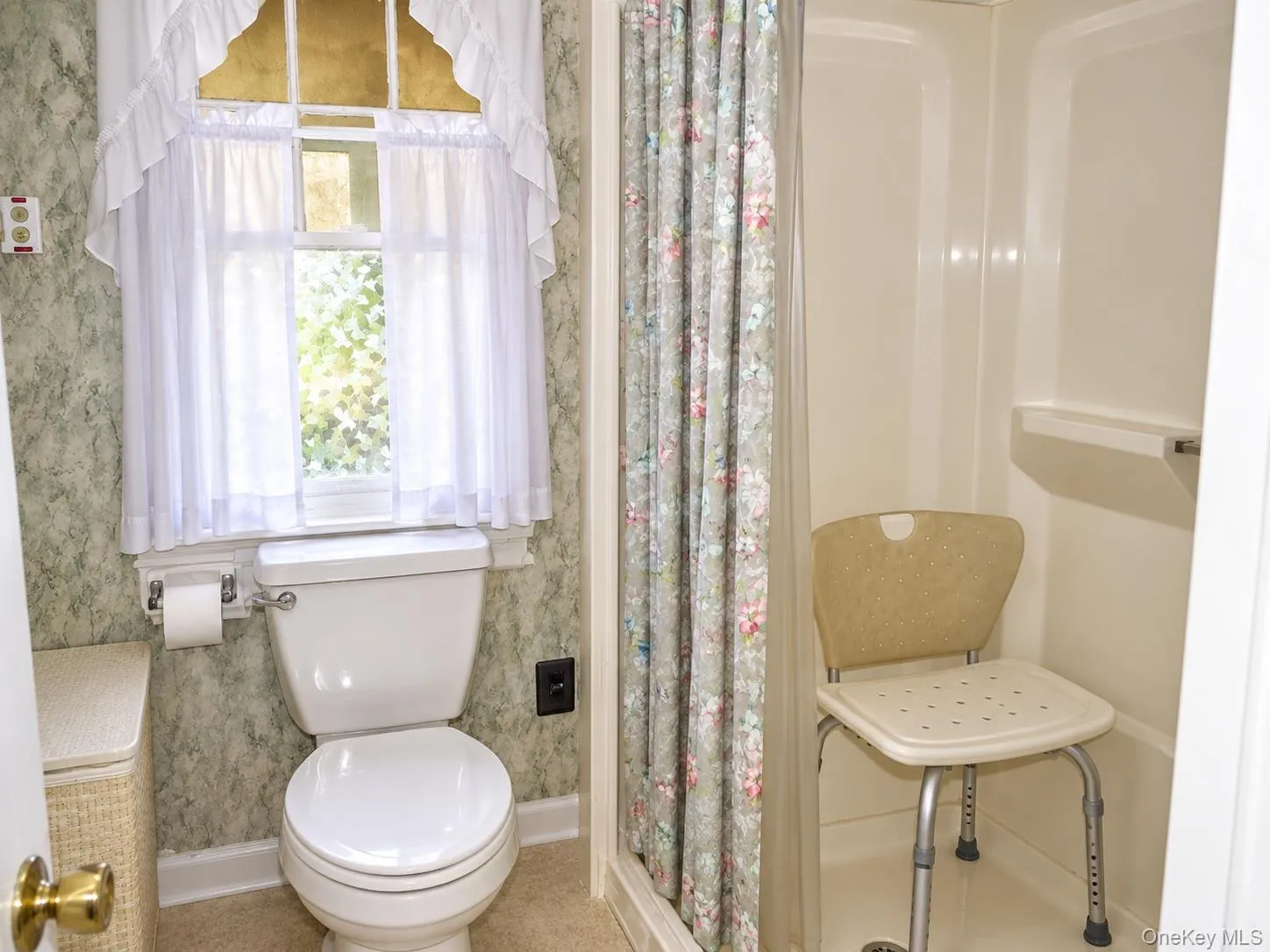Full bathroom with a white toilet and a built-in shower stall Full bathroom with a white toilet and a built-in shower stall