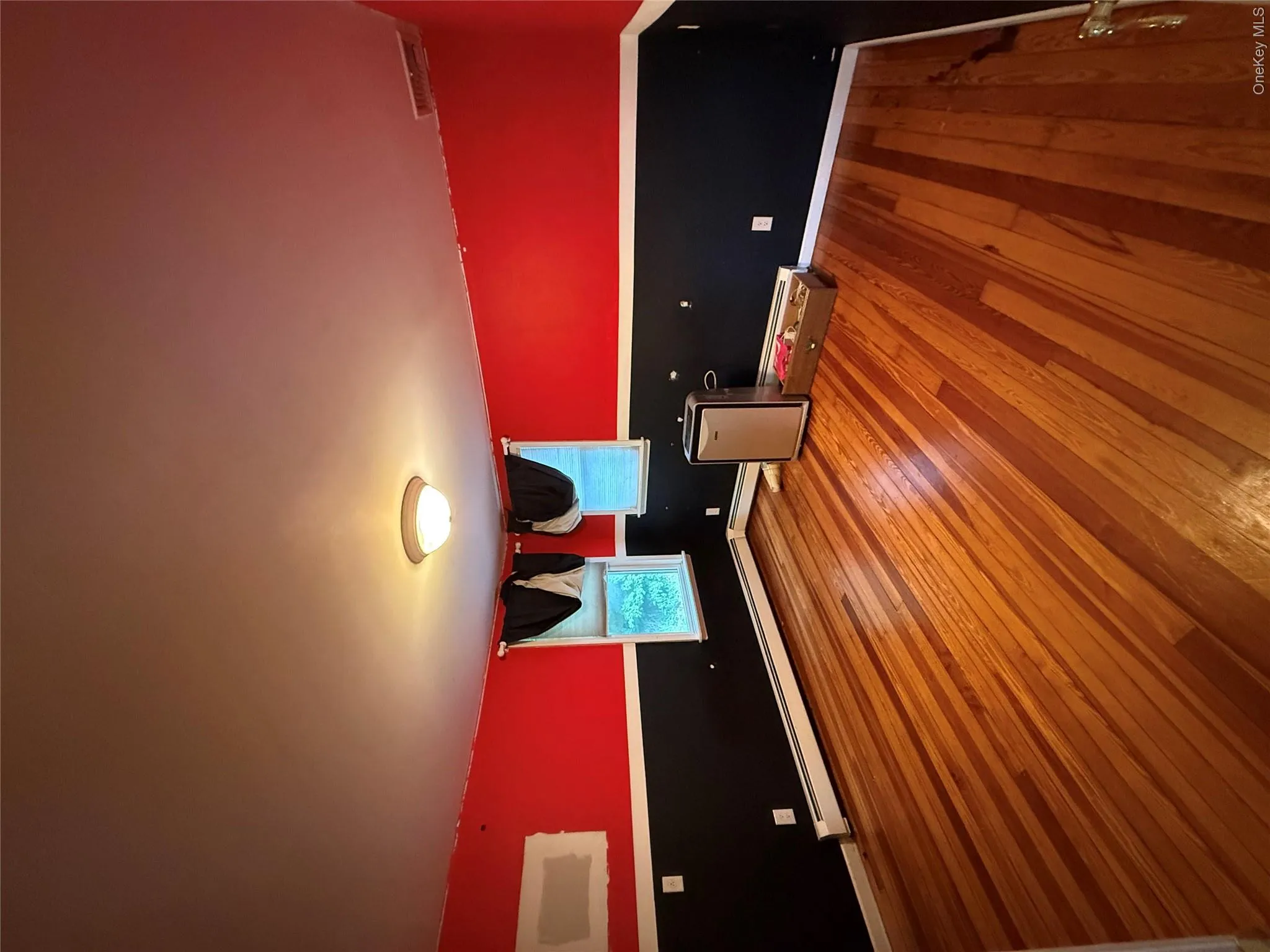 Hardwood flooring, two windows, and overhead lighting Hardwood flooring, two windows, and overhead lighting