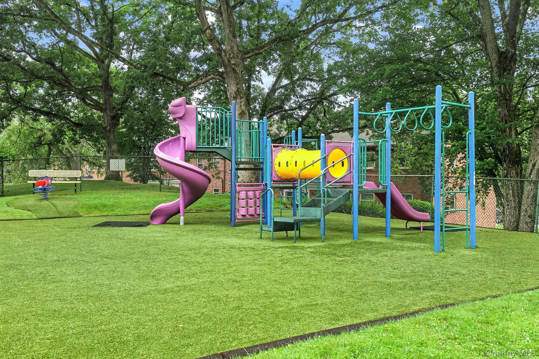 There is a playset and lots of running room at this Rex Ridge playground There is a playset and lots of running room at this Rex Ridge playground