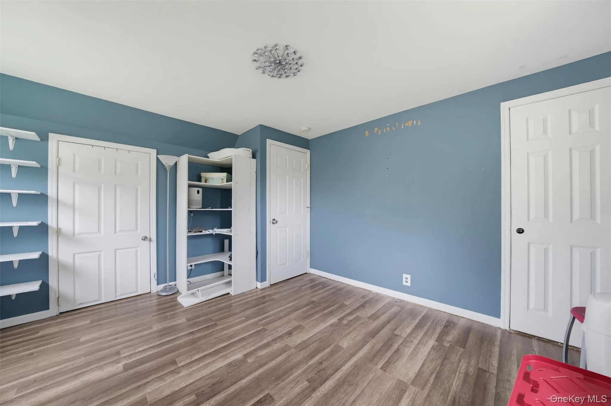 Wood-finish flooring with light blue wall paint Wood-finish flooring with light blue wall paint