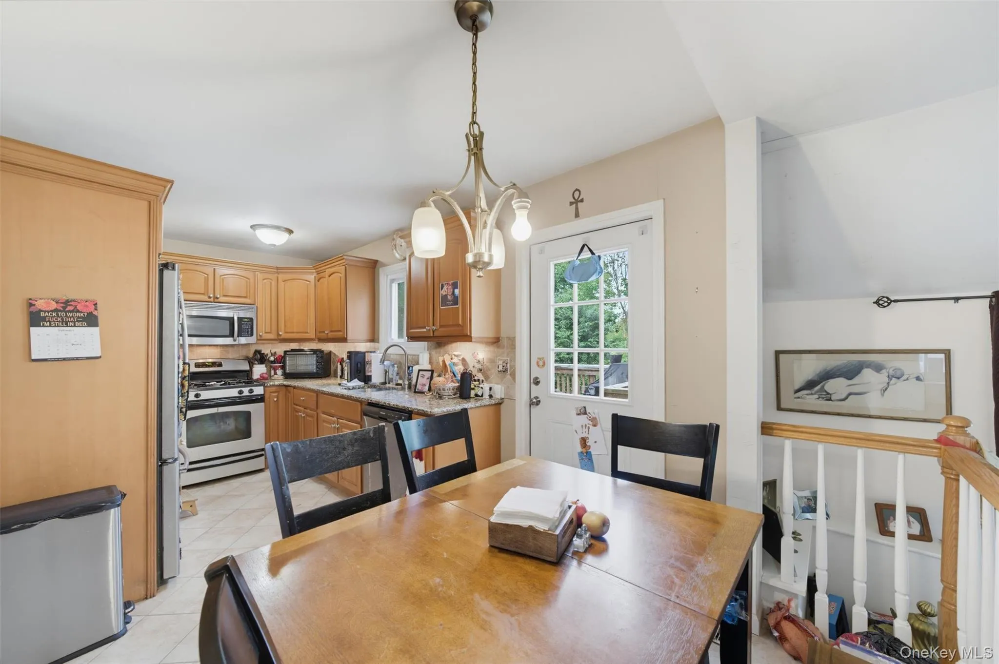 Kitchen featuring light wood-finish cabinetry, stainless steel appliances, and tiled flooring Kitchen featuring light wood-finish cabinetry, stainless steel appliances, and tiled flooring