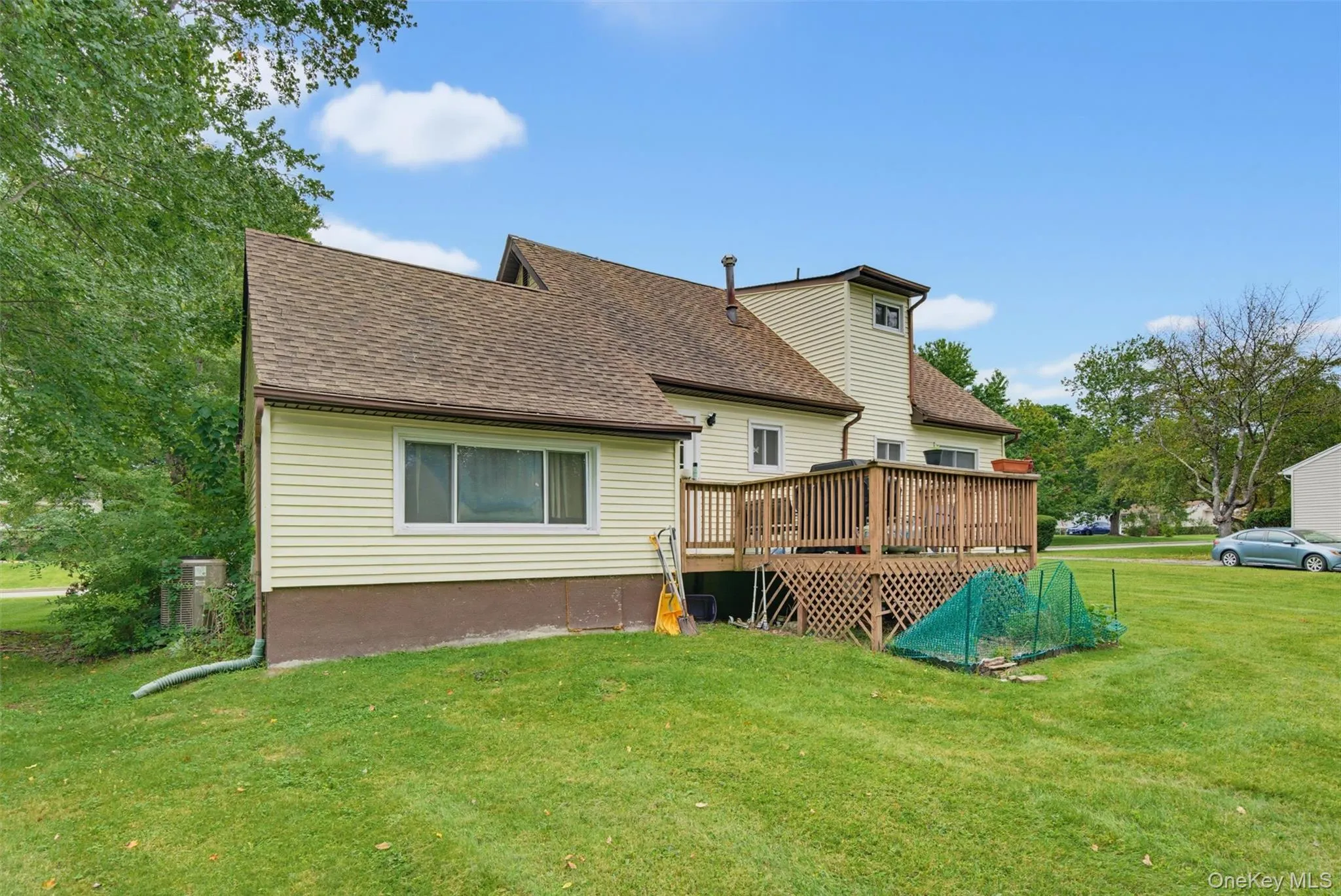 Rear deck with wood railing, providing outdoor living space Rear deck with wood railing, providing outdoor living space
