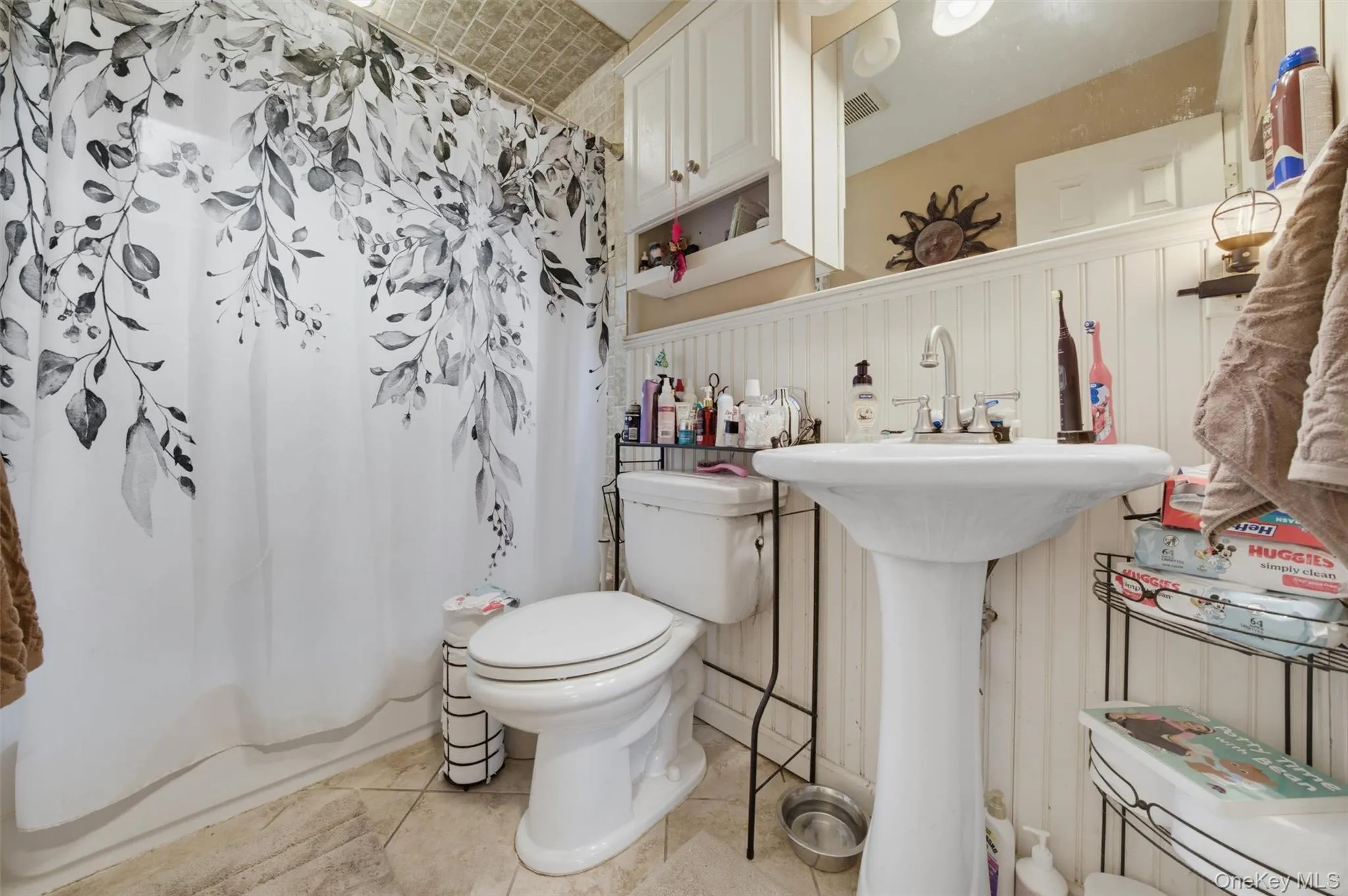 Bathroom with sink, bathtub with chrome fixtures and a vanity mirror Bathroom with sink, bathtub with chrome fixtures and a vanity mirror