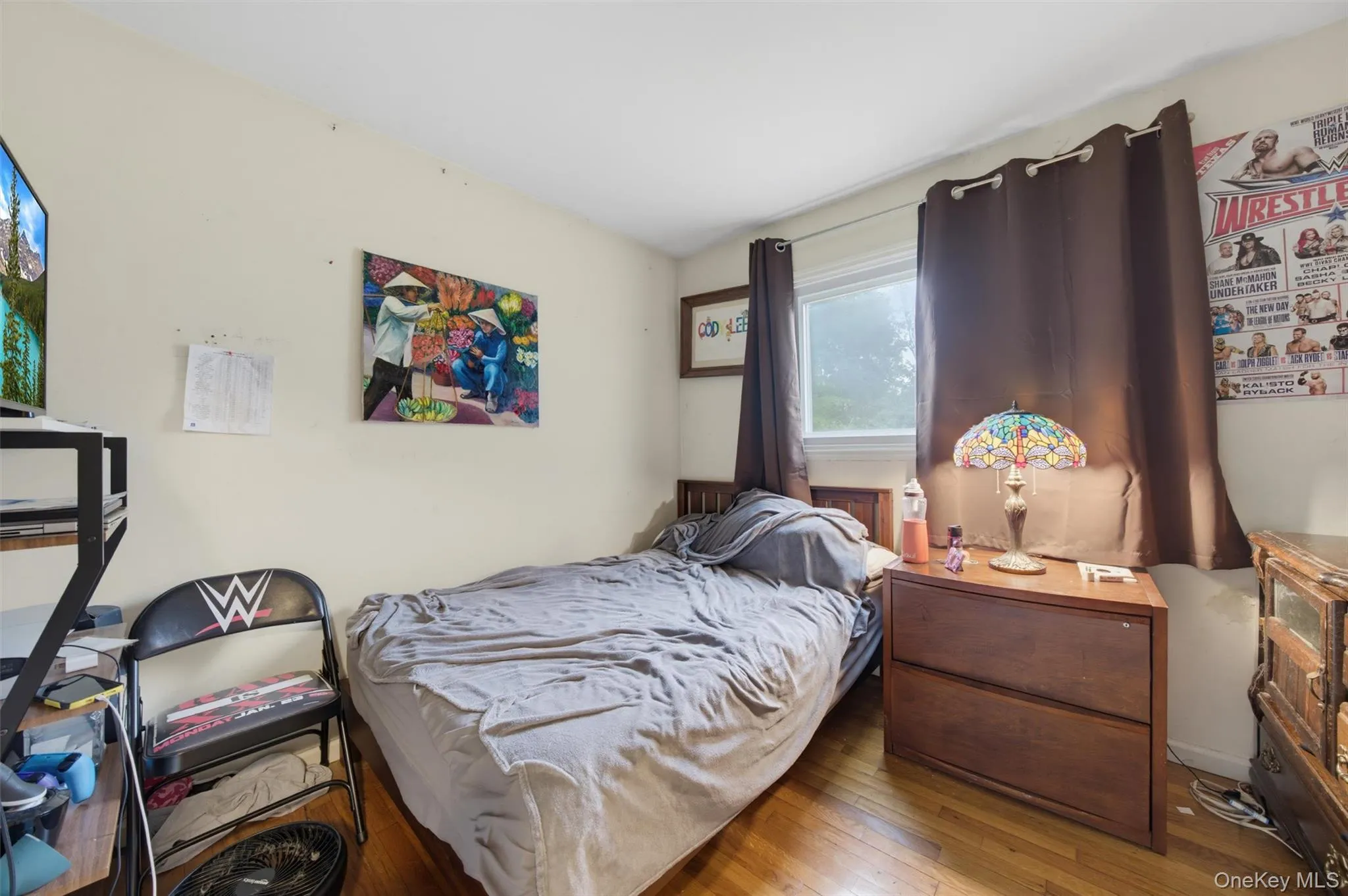 Hardwood-finish flooring, a window with drapery, and a built-in wall shelf Hardwood-finish flooring, a window with drapery, and a built-in wall shelf