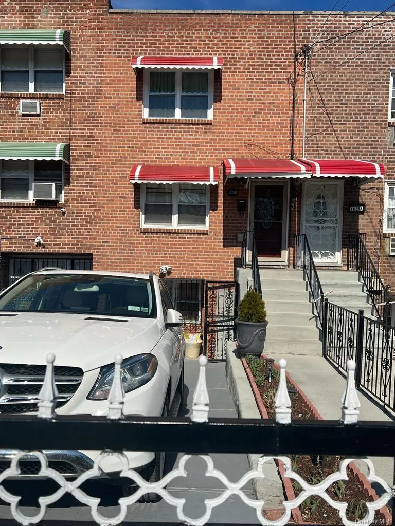 Brick facade with multiple windows, each featuring an awning Brick facade with multiple windows, each featuring an awning