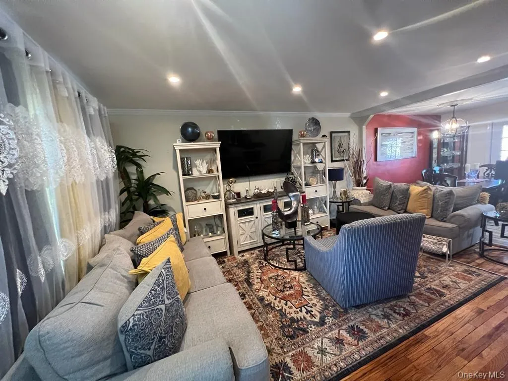 Recessed ceiling lighting illuminates the living space featuring wood-finish flooring Recessed ceiling lighting illuminates the living space featuring wood-finish flooring