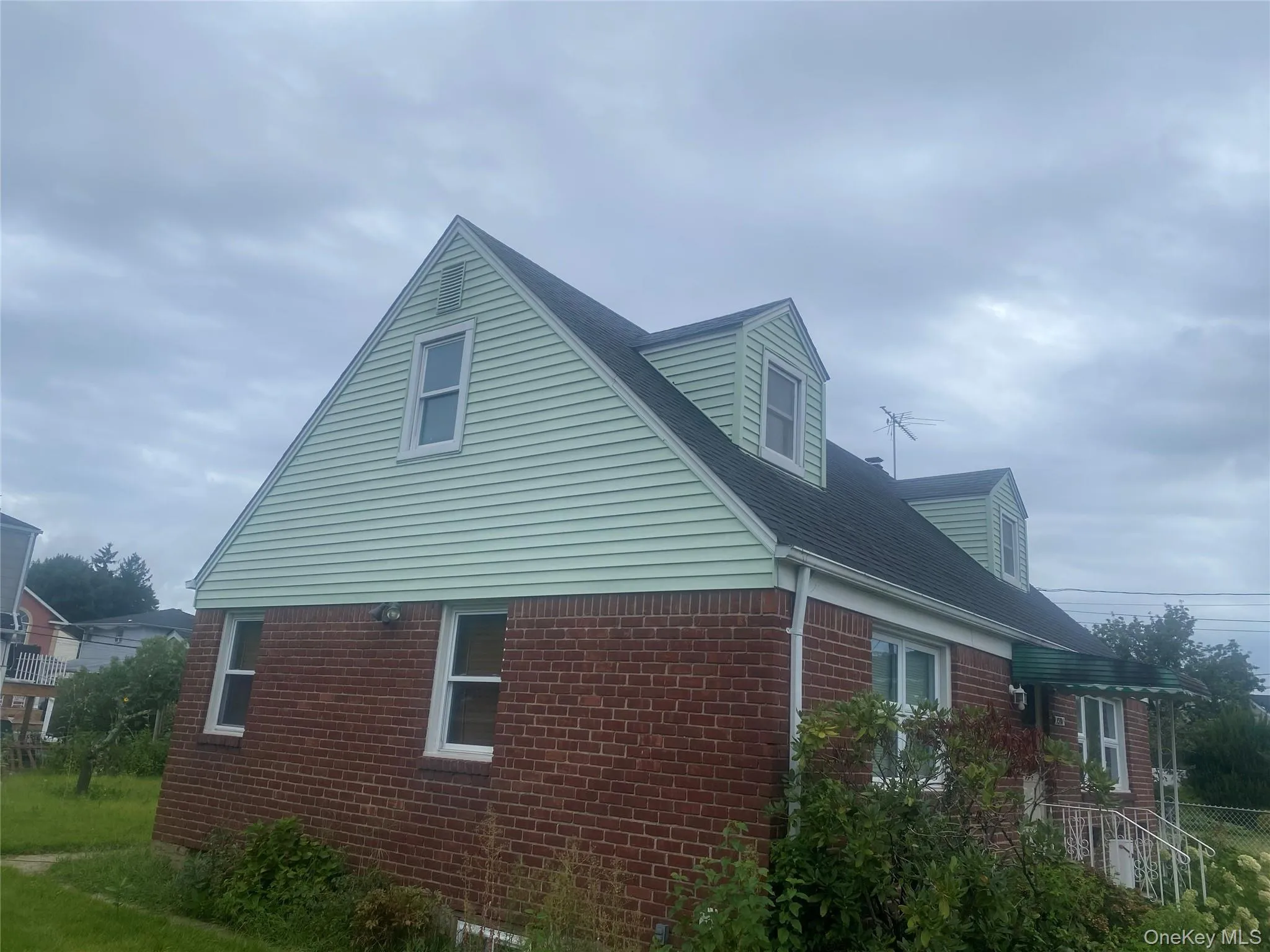 Brick and siding exterior with gabled roofline Brick and siding exterior with gabled roofline