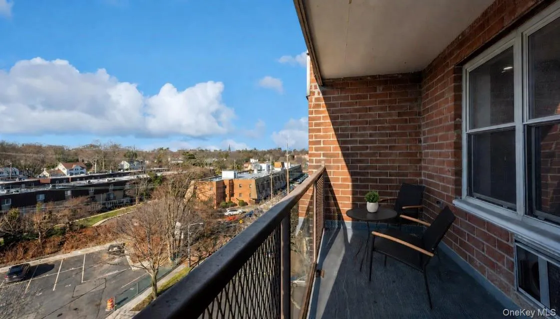 Private covered balcony offering open neighborhood views and a comfortable outdoor space for morning coffee, fresh air or unwinding at the end of the day. Private covered balcony offering open neighborhood views and a comfortable outdoor space for morning coffee, fresh air or unwinding at the end of the day.