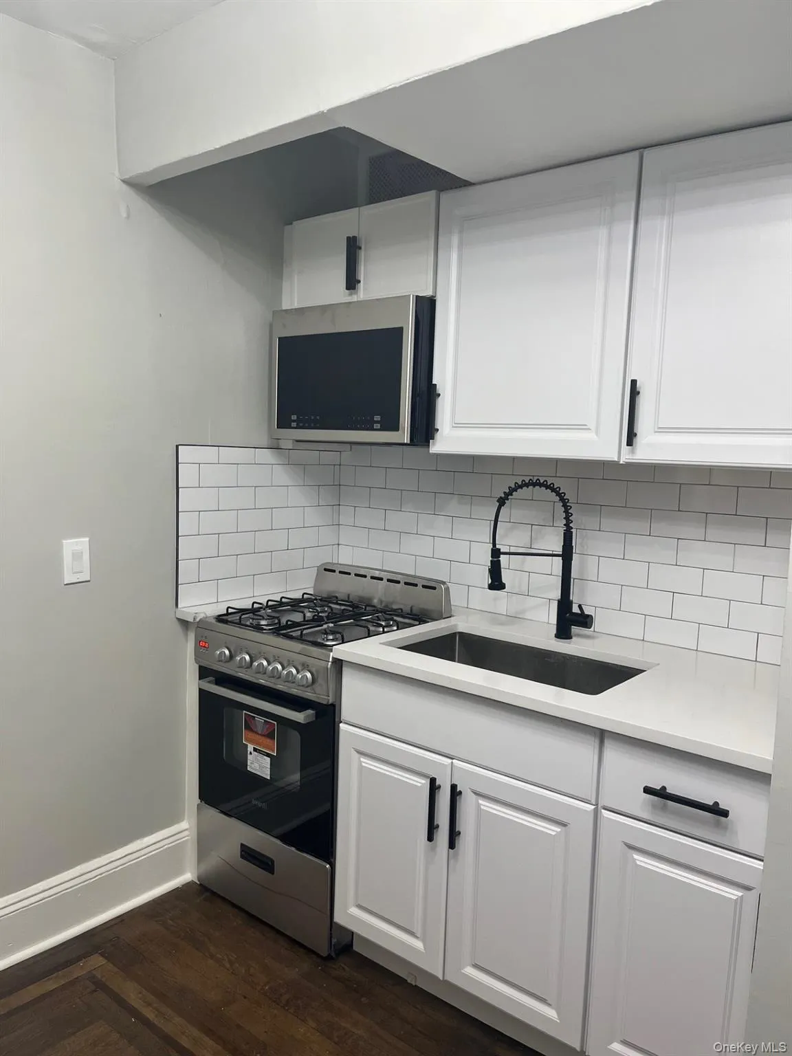 Kitchen featuring stainless steel appliances, white cabinets & Quartz countertops Kitchen featuring stainless steel appliances, white cabinets & Quartz countertops