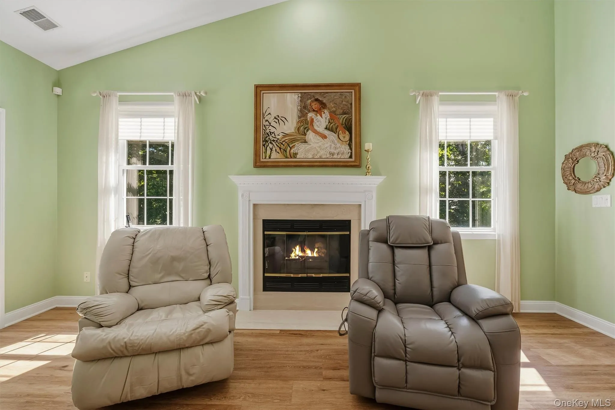 Vaulted ceiling, fireplace with mantel, dual paned windows, wood-finish flooring Vaulted ceiling, fireplace with mantel, dual paned windows, wood-finish flooring