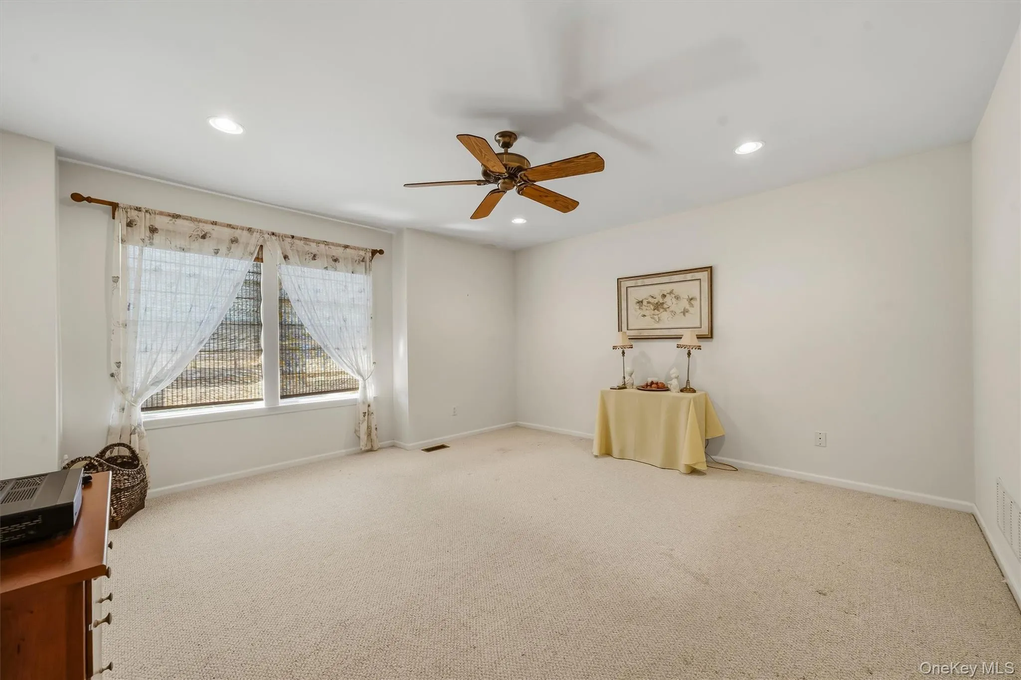Recessed lighting, ceiling fan, and carpeted flooring Recessed lighting, ceiling fan, and carpeted flooring