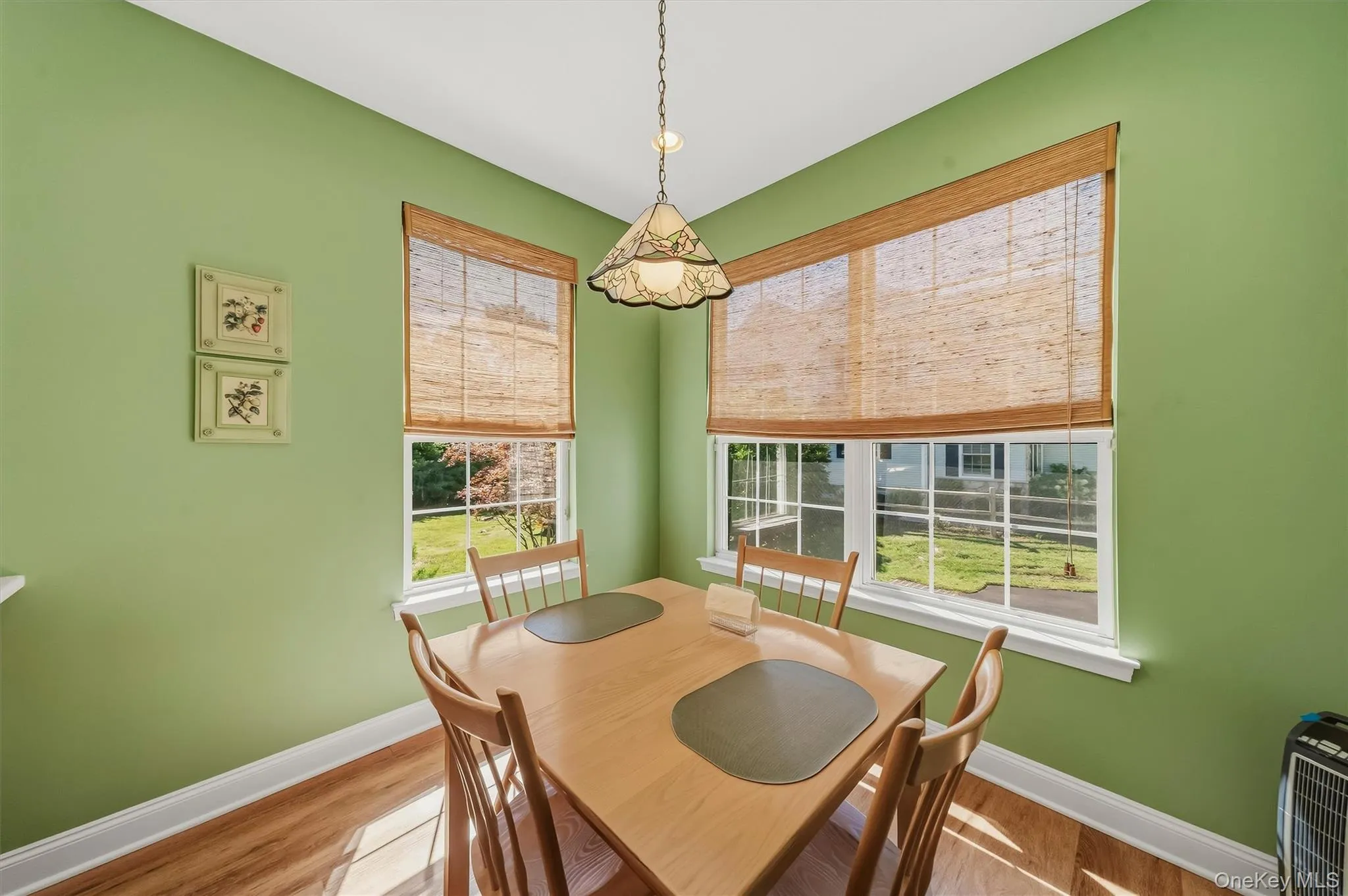Wood-finish flooring with white trim and baseboards Wood-finish flooring with white trim and baseboards