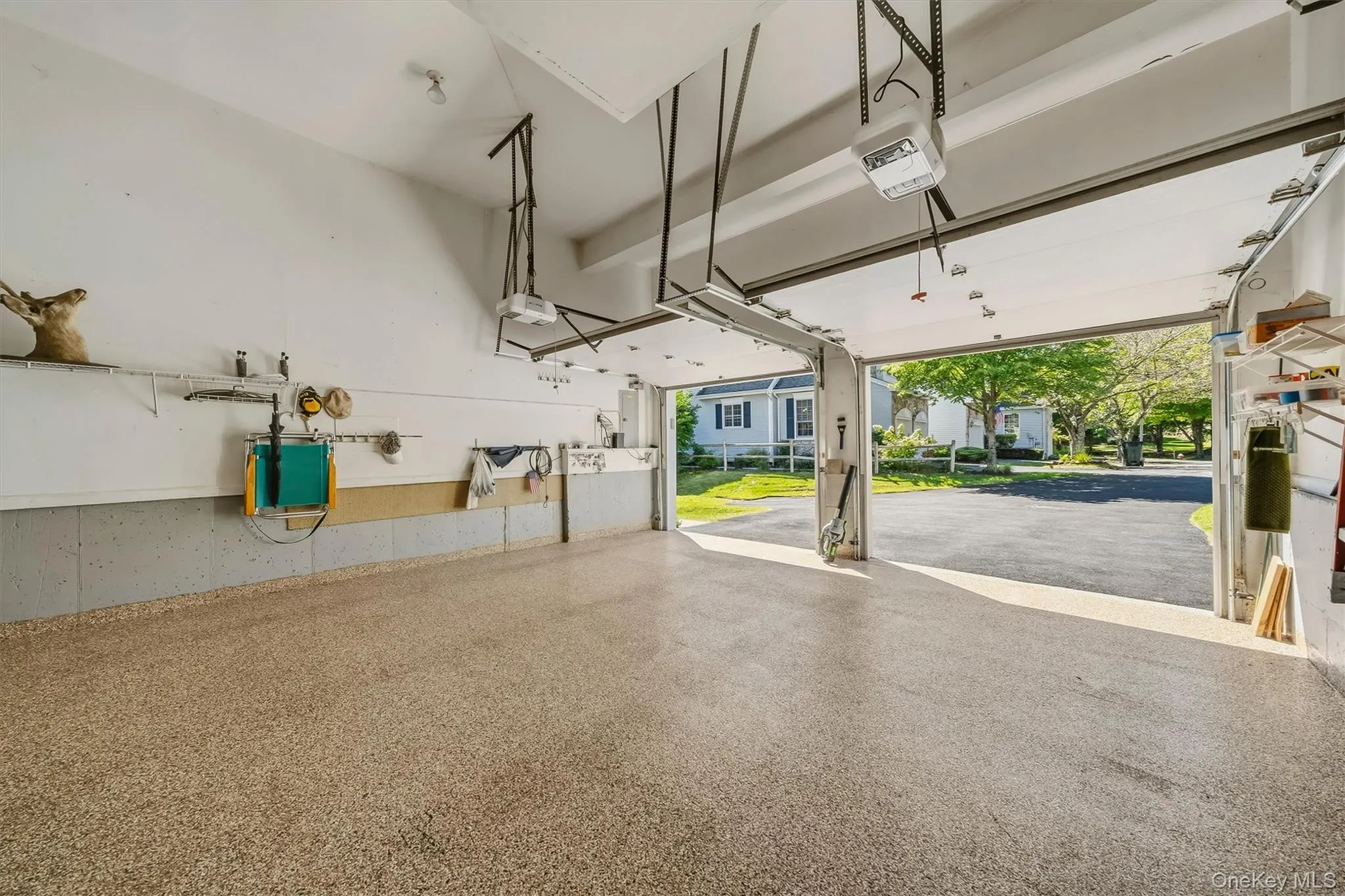 Epoxy-coated concrete flooring, two automatic garage door openers, and built-in shelving Epoxy-coated concrete flooring, two automatic garage door openers, and built-in shelving