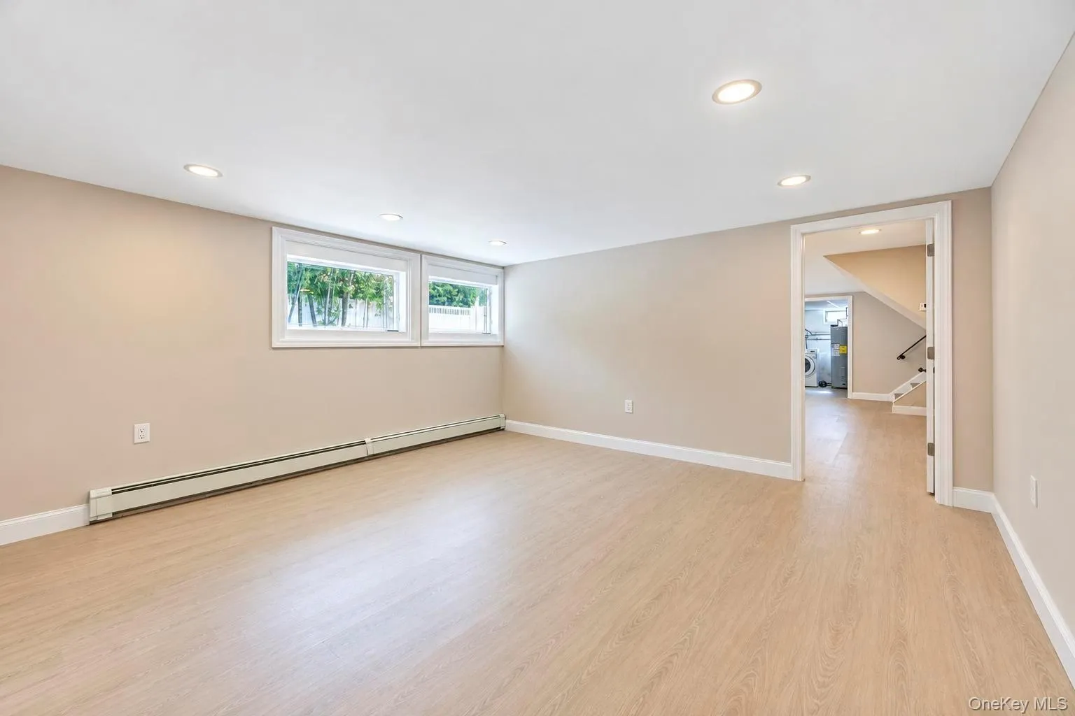 Recessed lighting, wood-finish flooring, multiple windows, and a neutral color palette Recessed lighting, wood-finish flooring, multiple windows, and a neutral color palette
