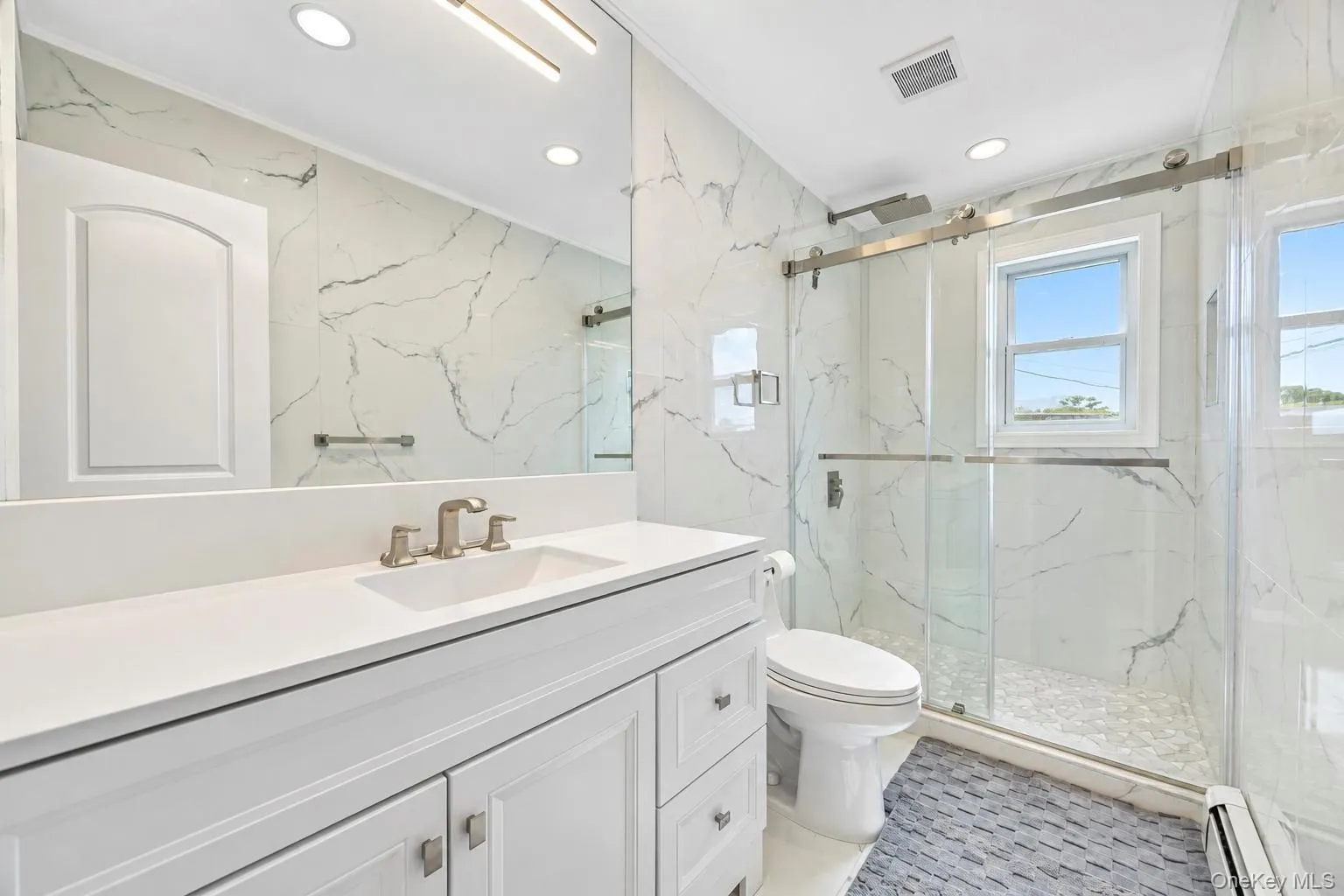 White vanity with brushed nickel hardware, integrated sink, and brushed nickel faucet White vanity with brushed nickel hardware, integrated sink, and brushed nickel faucet