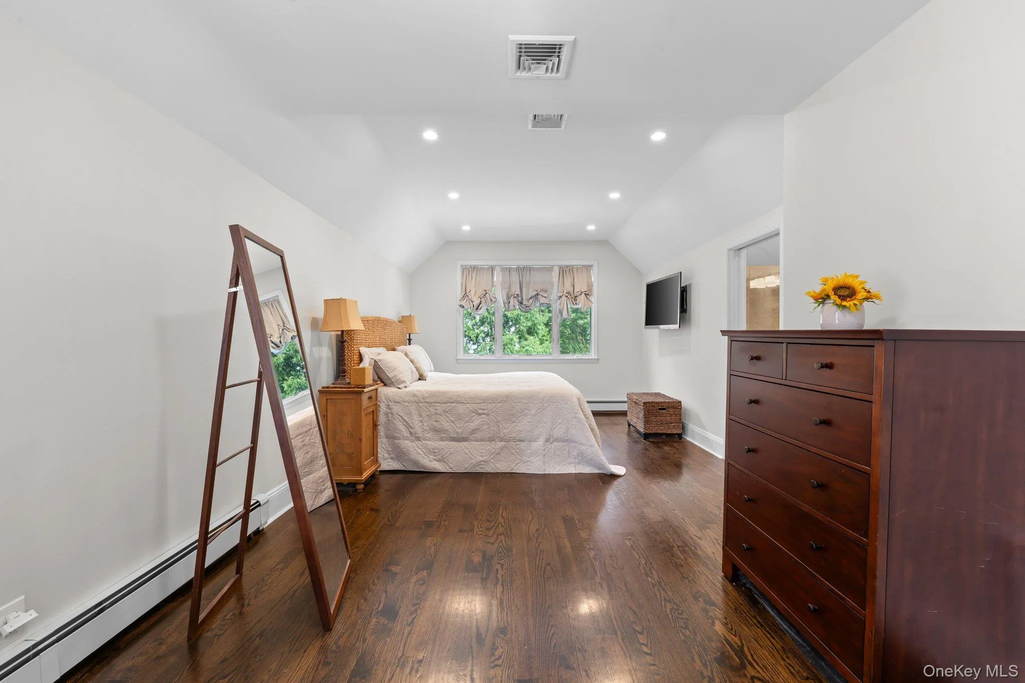 Wood-finish flooring, recessed lighting, white walls, and a triple panel window bringing in lots of natural light. Wood-finish flooring, recessed lighting, white walls, and a triple panel window bringing in lots of natural light.