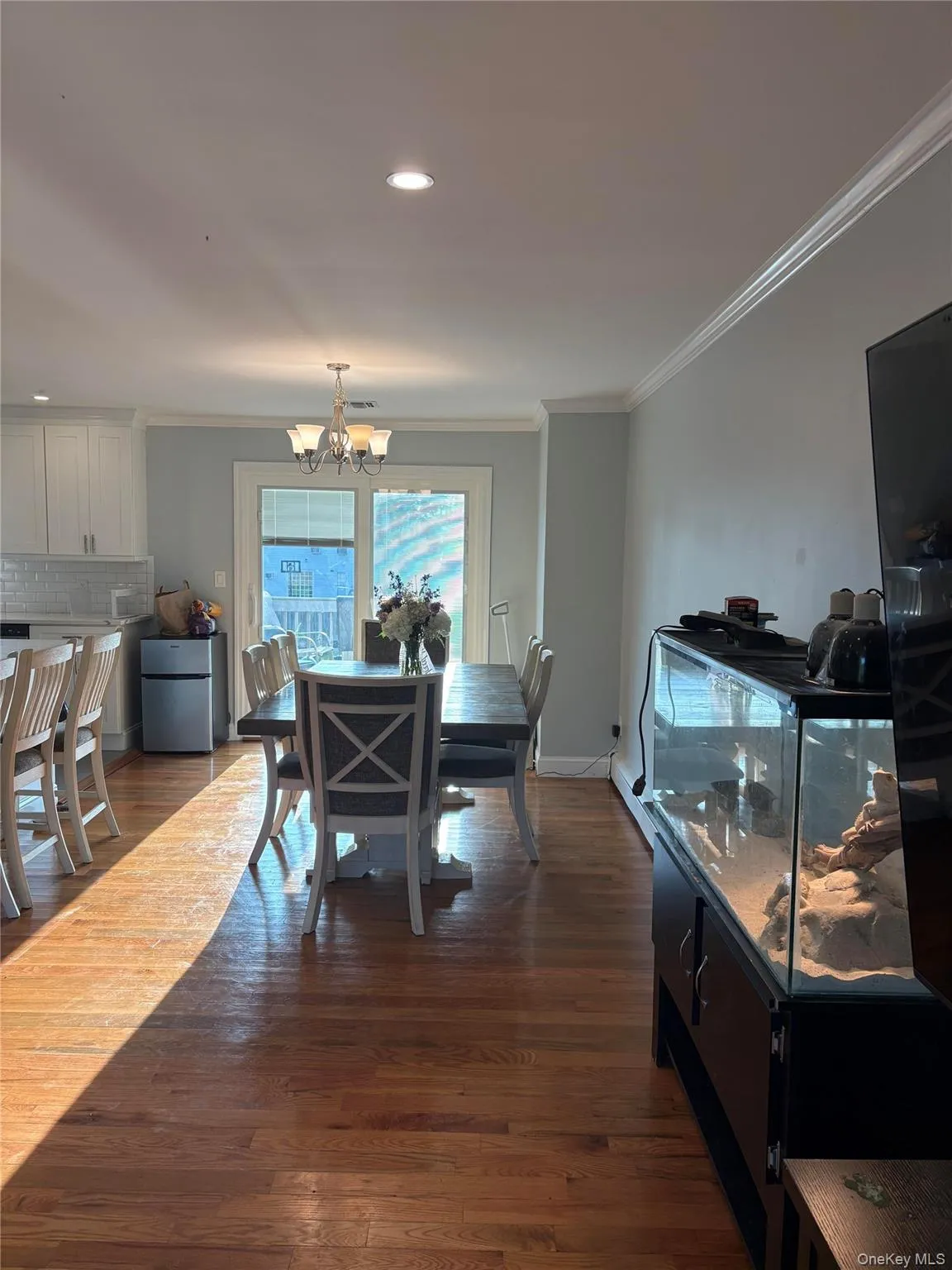 Hardwood flooring throughout, recessed ceiling lighting, crown molding, and a chandelier light fixture Hardwood flooring throughout, recessed ceiling lighting, crown molding, and a chandelier light fixture