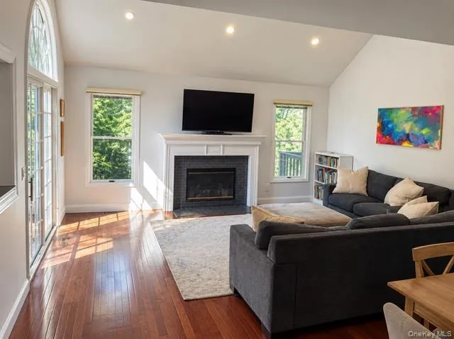 First floor living room with fireplace and sliding glass dorrs to deck. First floor living room with fireplace and sliding glass dorrs to deck.