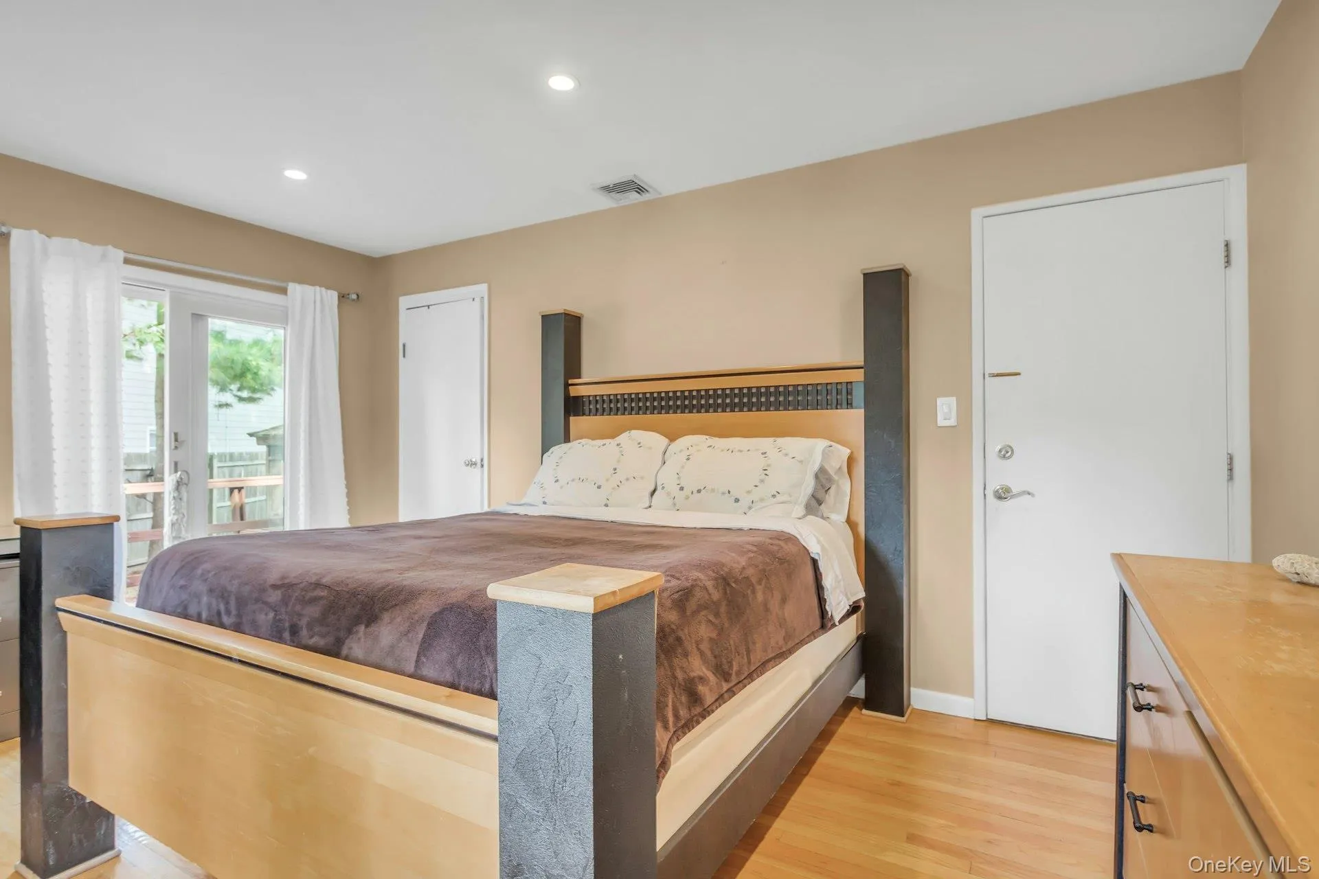 Recessed lighting, wood-finish flooring, light-colored walls, white trim, and a white door Recessed lighting, wood-finish flooring, light-colored walls, white trim, and a white door