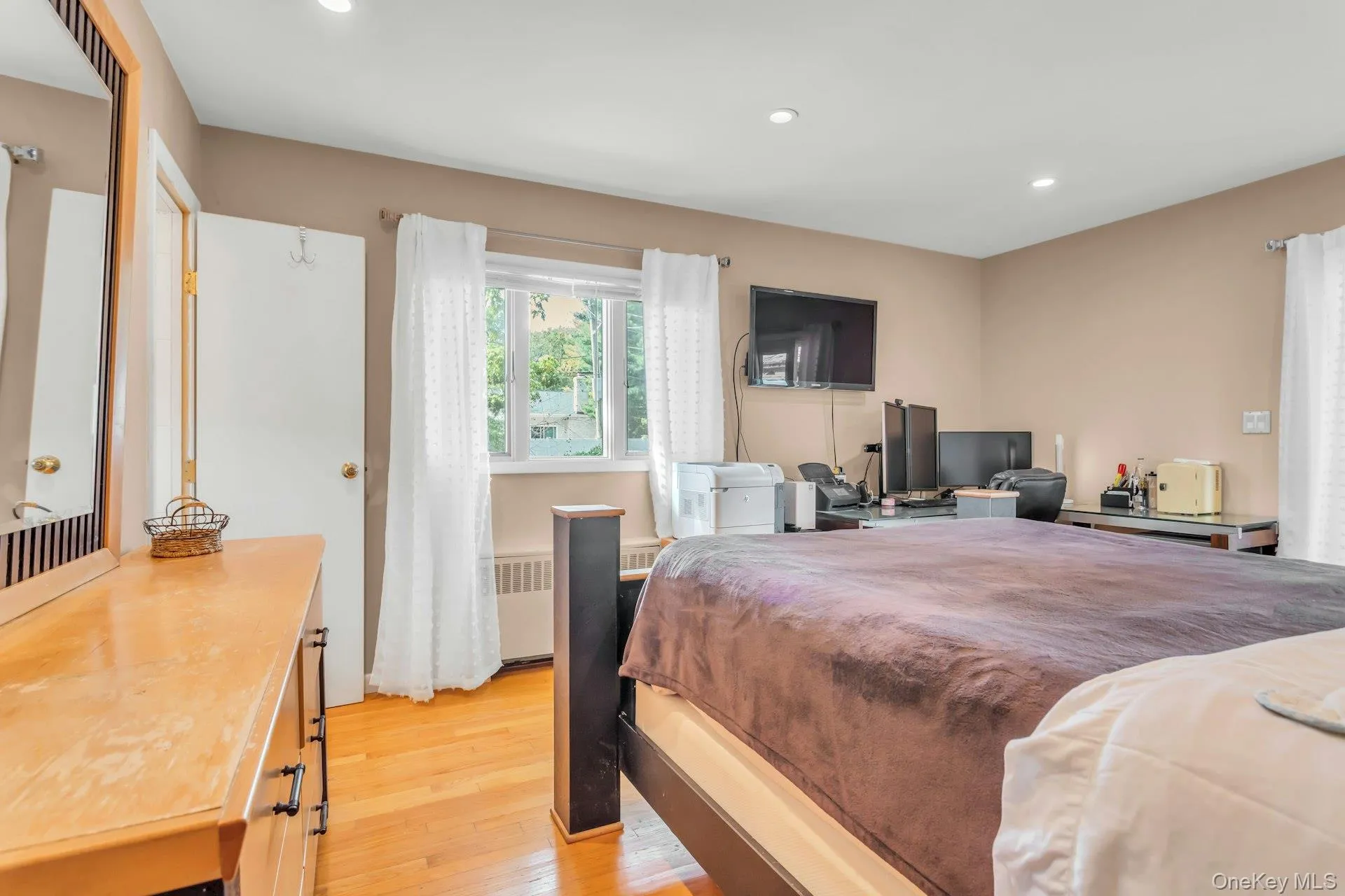 Hardwood flooring, recessed lighting, and ample natural light from a multi-pane window Hardwood flooring, recessed lighting, and ample natural light from a multi-pane window