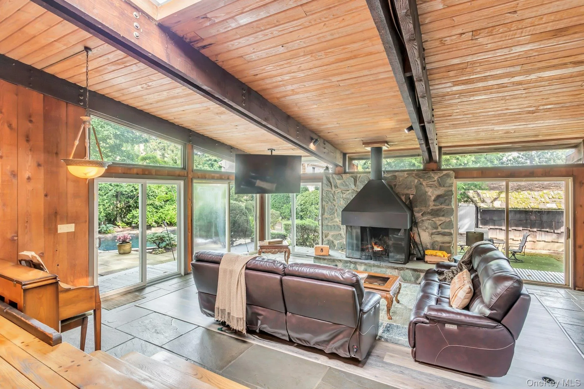 Wood-paneled walls and a wood-plank ceiling with exposed beams Wood-paneled walls and a wood-plank ceiling with exposed beams