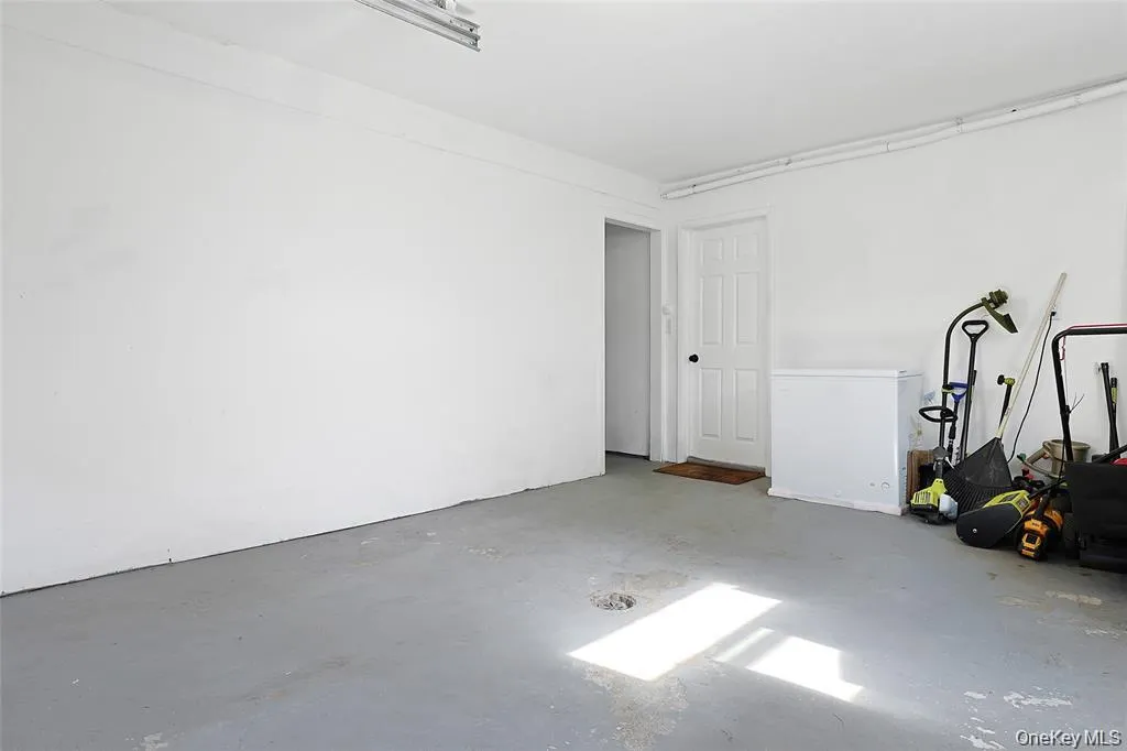 2 car garage with a wall departing both bays. Door on left to other bay. 2 car garage with a wall departing both bays. Door on left to other bay.