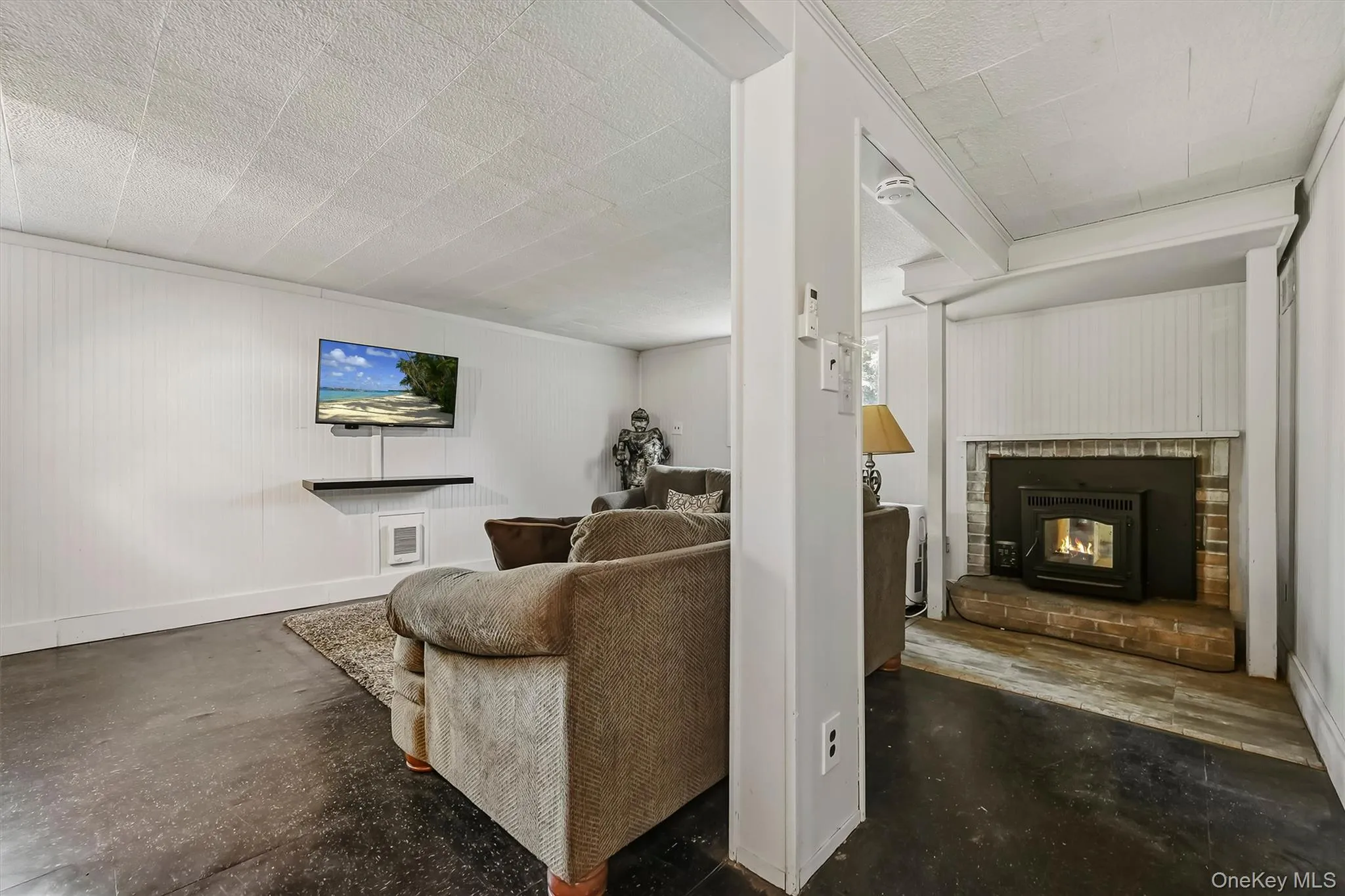This view shows the fireplace with pellet stove to supplement any fuel costs. This view shows the fireplace with pellet stove to supplement any fuel costs.