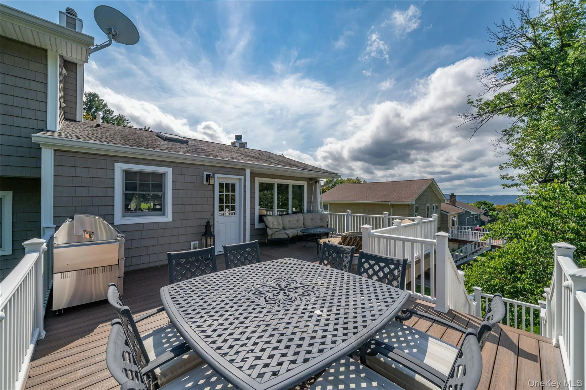 Designed for both entertaining and relaxing, the oversized deck offers multiple areas for dining, grilling and lounging, creating a true extension of the home's living space. Designed for both entertaining and relaxing, the oversized deck offers multiple areas for dining, grilling and lounging, creating a true extension of the home's living space.