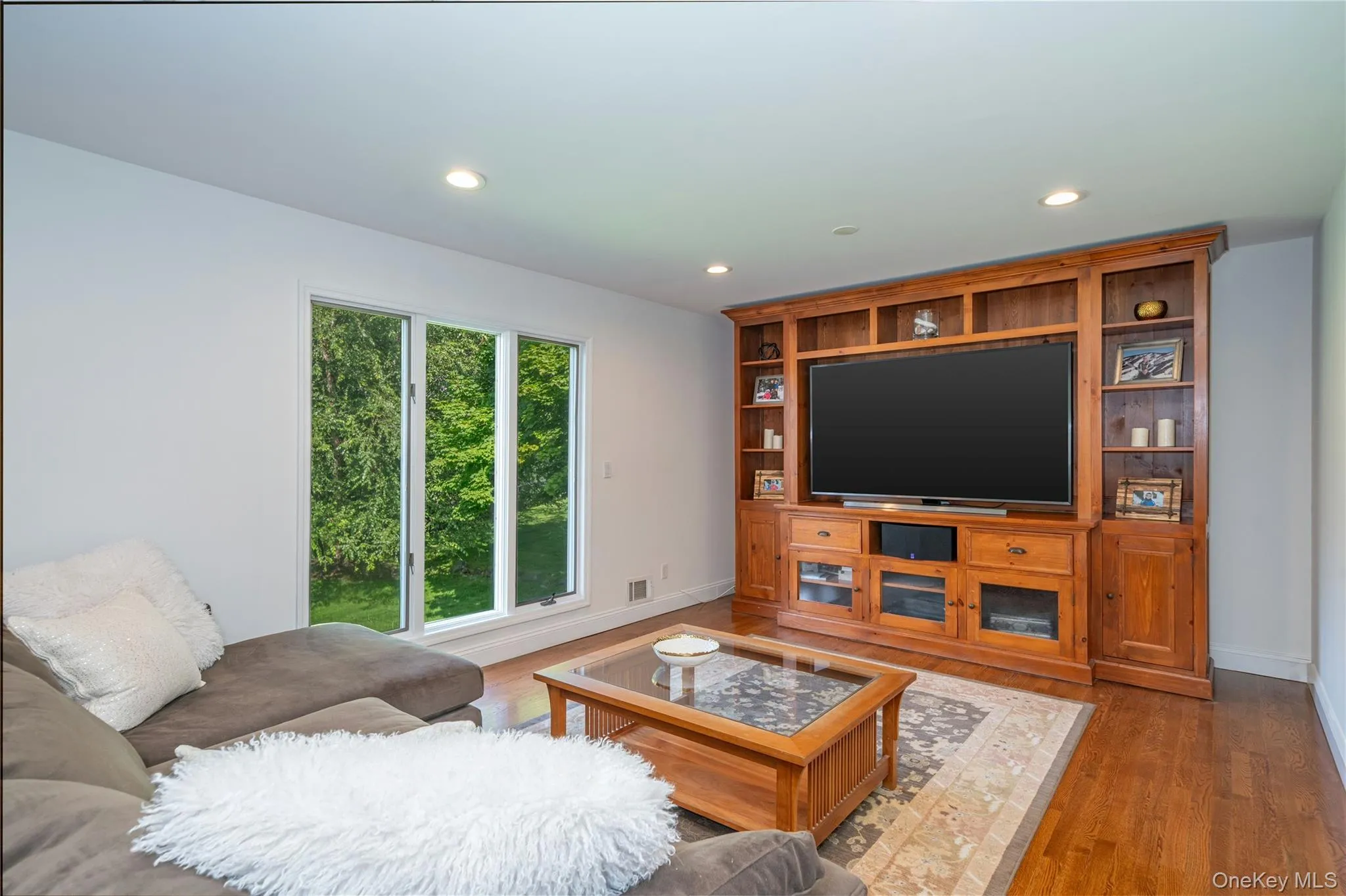 A spacious family room offers a comfortable retreat with abundant natural light and plenty of room for relaxing, gathering or watching TV. A spacious family room offers a comfortable retreat with abundant natural light and plenty of room for relaxing, gathering or watching TV.