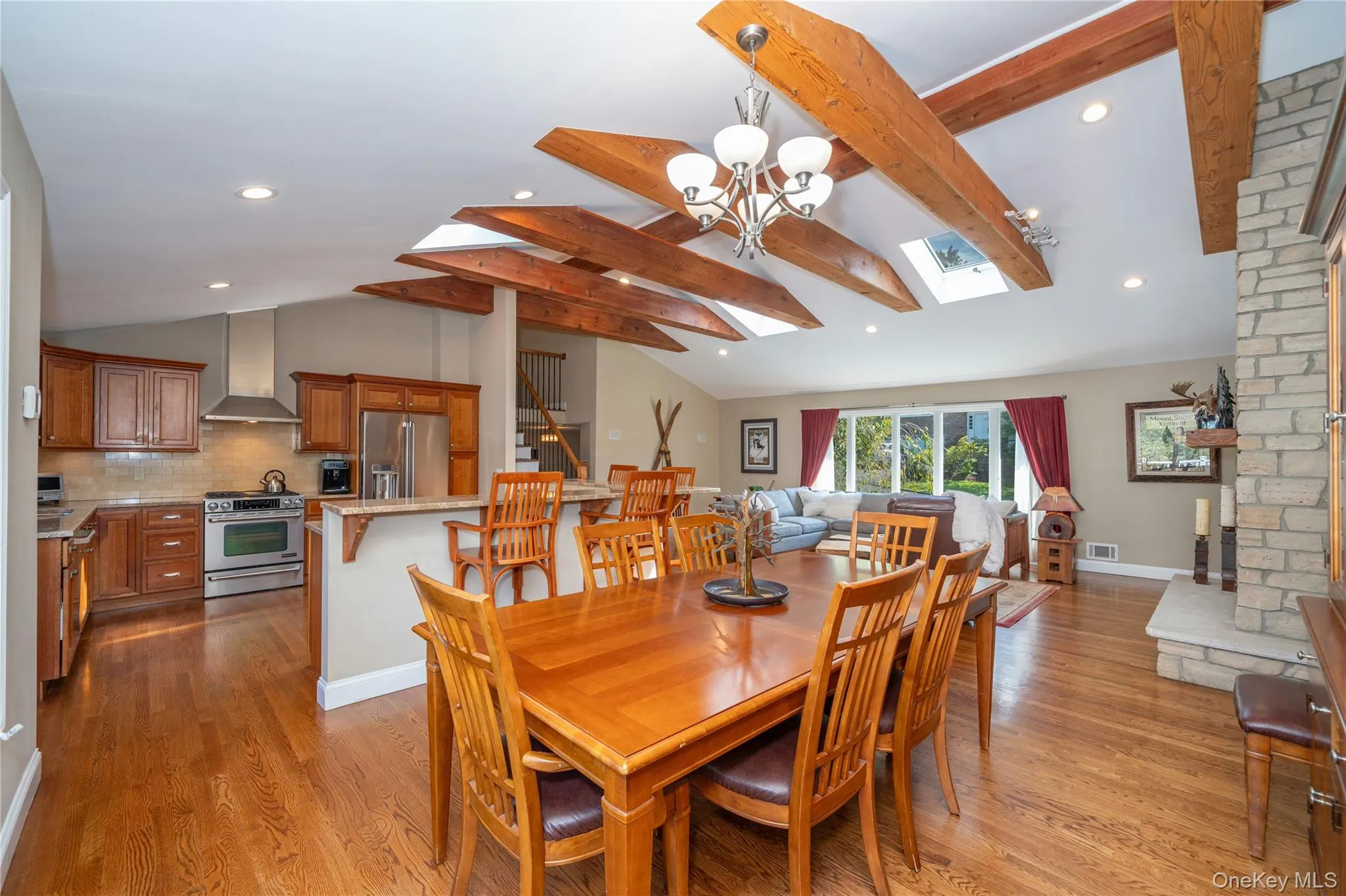 The dining area flows seamlessly into the dramatic living room, highlighting the home's open layout and easy connection between spaces. The dining area flows seamlessly into the dramatic living room, highlighting the home's open layout and easy connection between spaces.