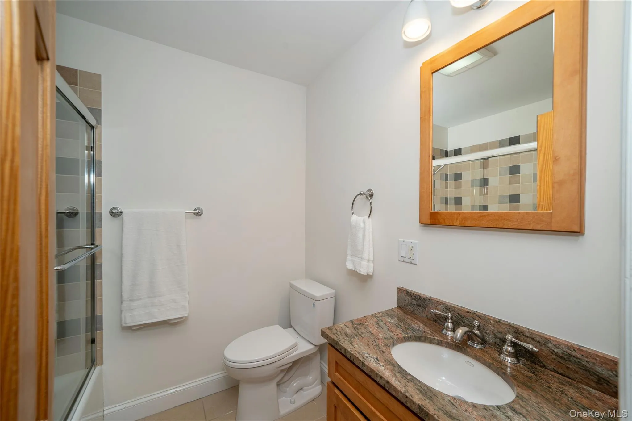 The full hall bath features attractive tilework in the tub/shower and a granite-topped vanity. The full hall bath features attractive tilework in the tub/shower and a granite-topped vanity.