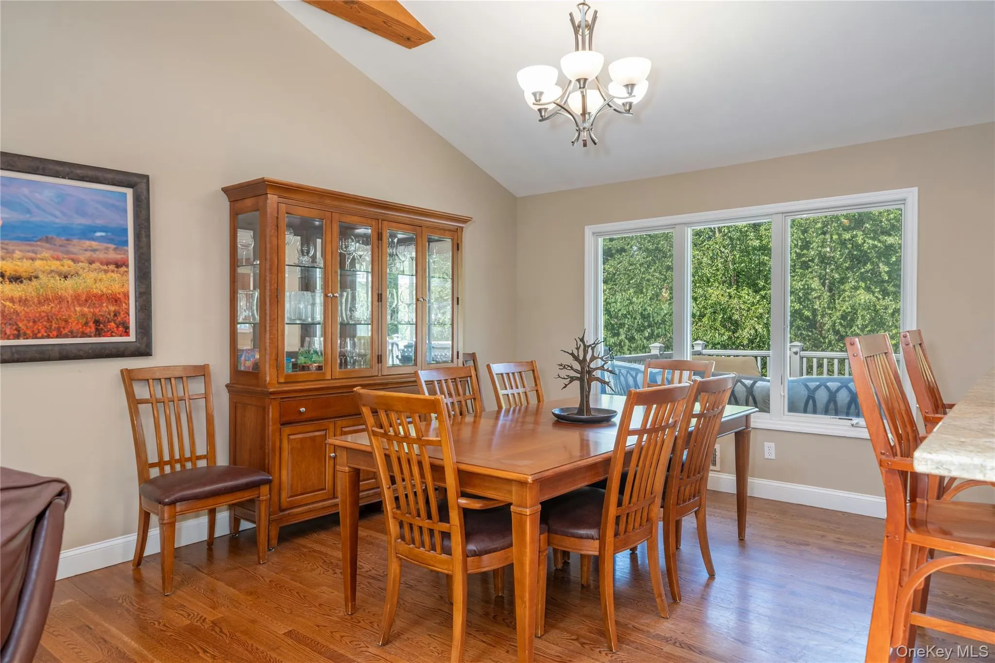 The light-filled dining area is framed by large windows overlooking the greenery, creating an inviting setting for everything from casual meals to special gatherings. The light-filled dining area is framed by large windows overlooking the greenery, creating an inviting setting for everything from casual meals to special gatherings.