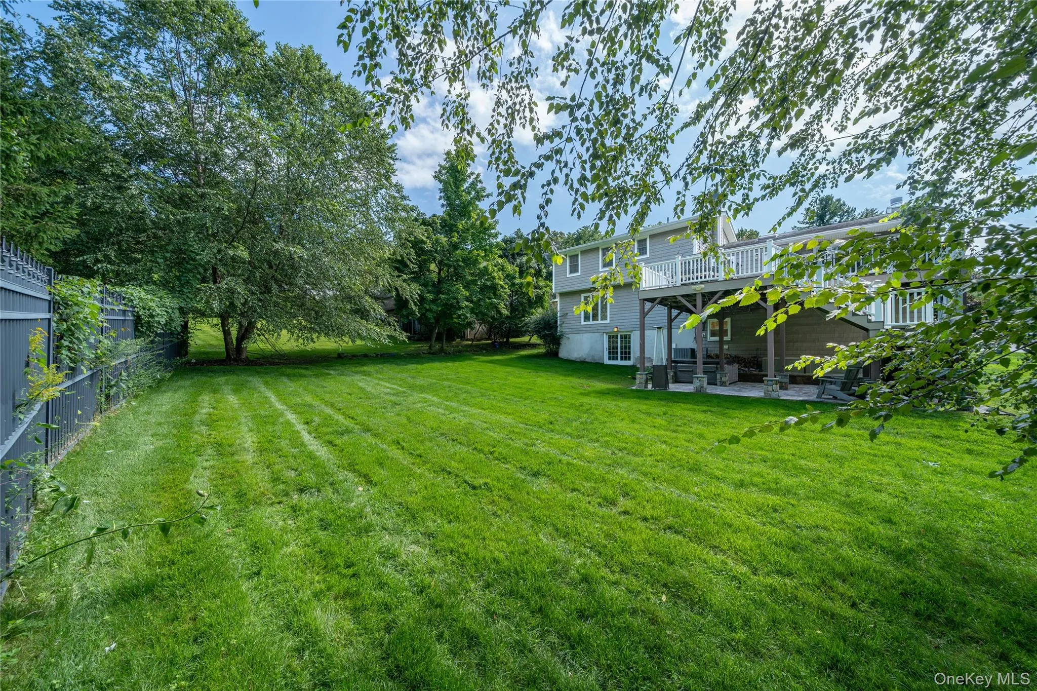 A final look at the home highlights the large, level backyard - plenty of usable lawn for play, recreation and outdoor enjoyment, with the deck, patio and home providing the backdrop. A final look at the home highlights the large, level backyard - plenty of usable lawn for play, recreation and outdoor enjoyment, with the deck, patio and home providing the backdrop.